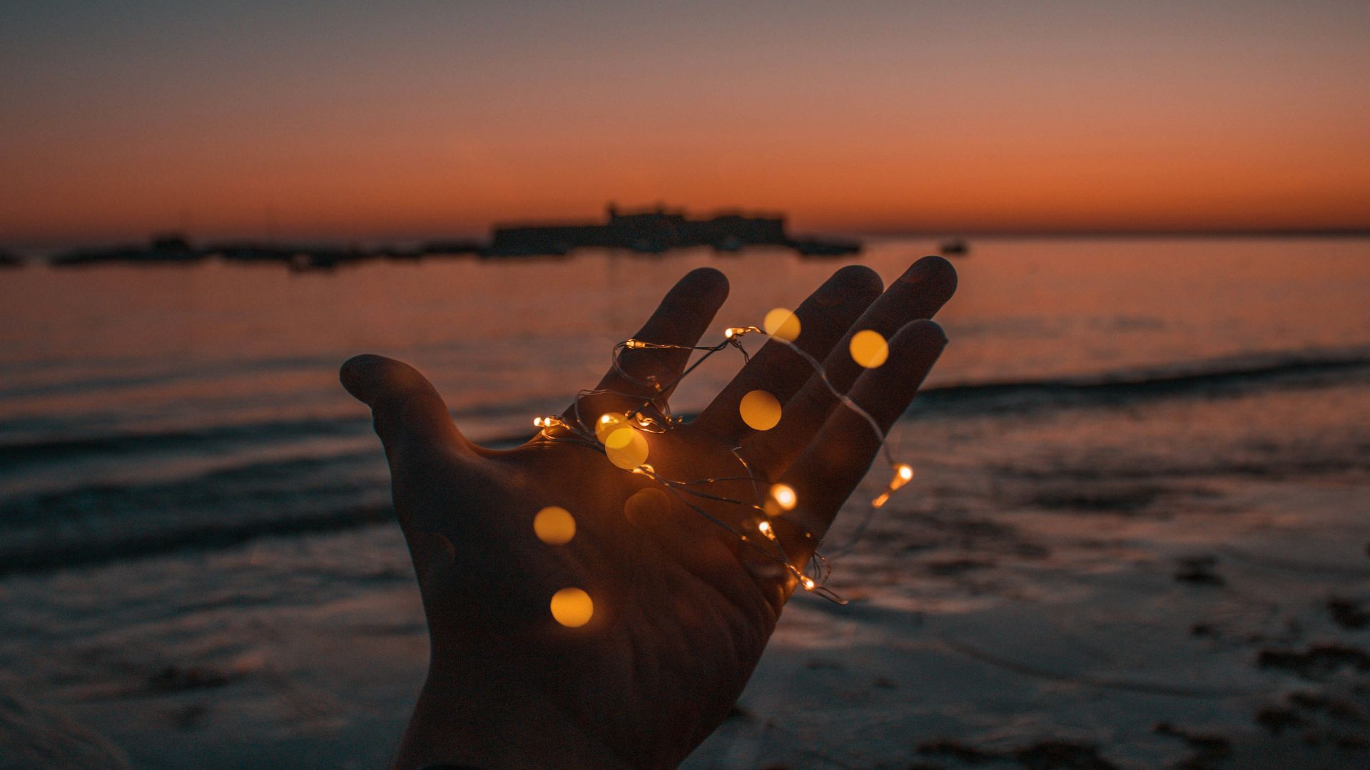 person with string lights on left hand