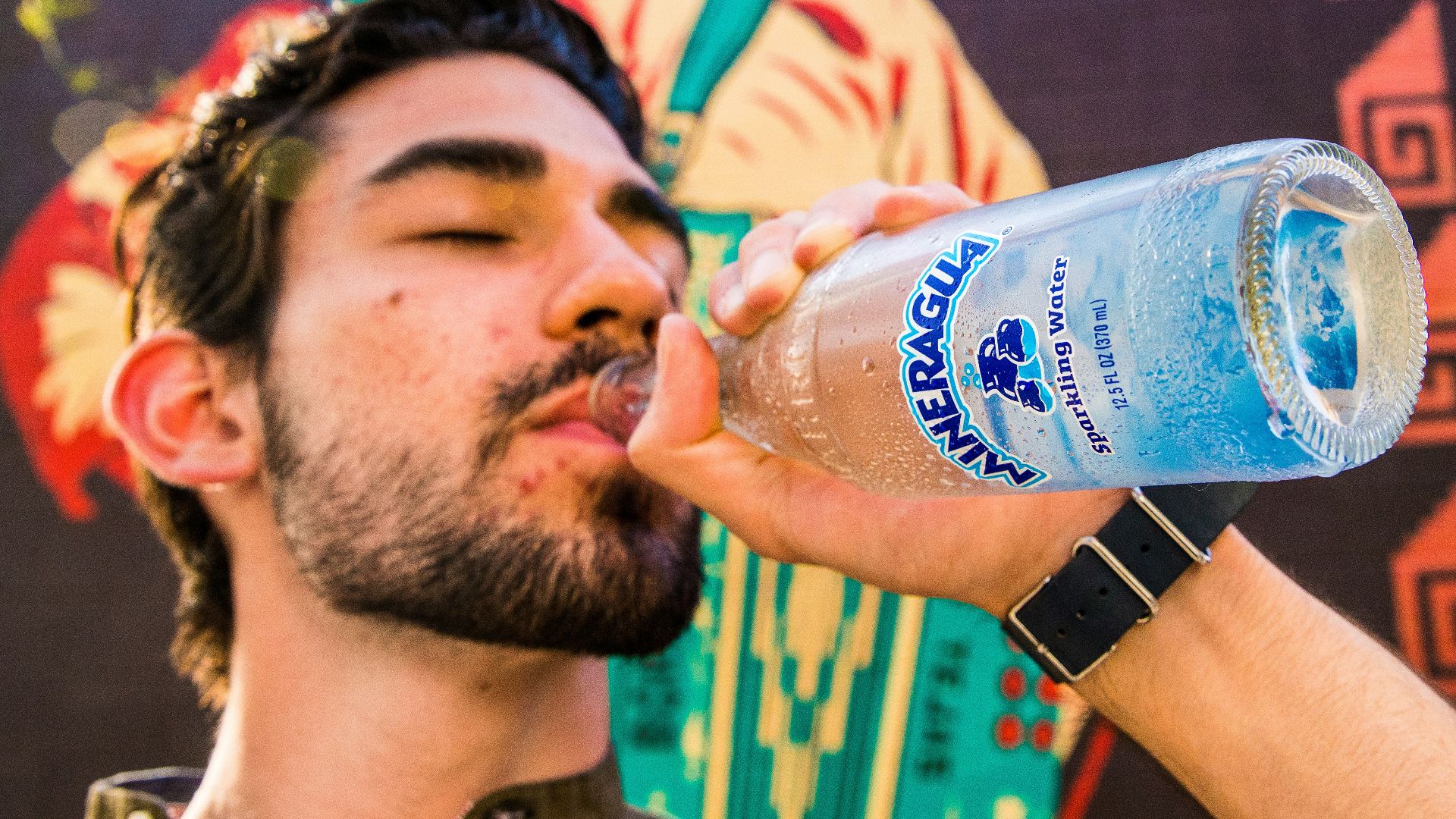 man in black crew neck t-shirt drinking pepsi bottle