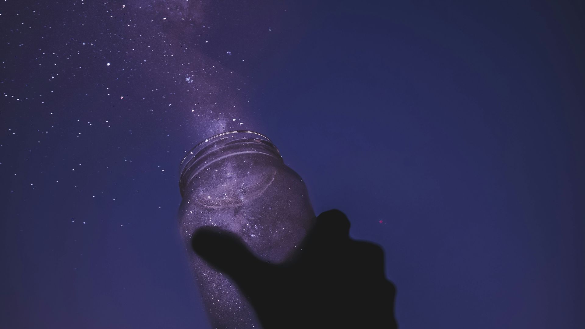 person holding glass jar