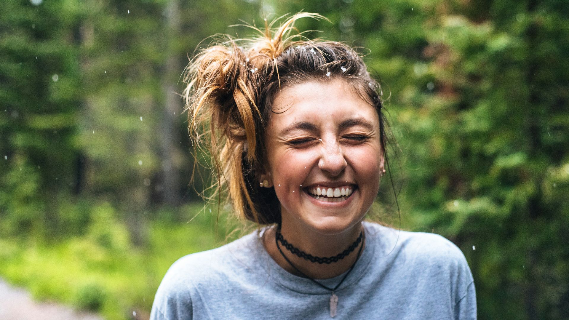 woman smiling near tree outdoor during daytime