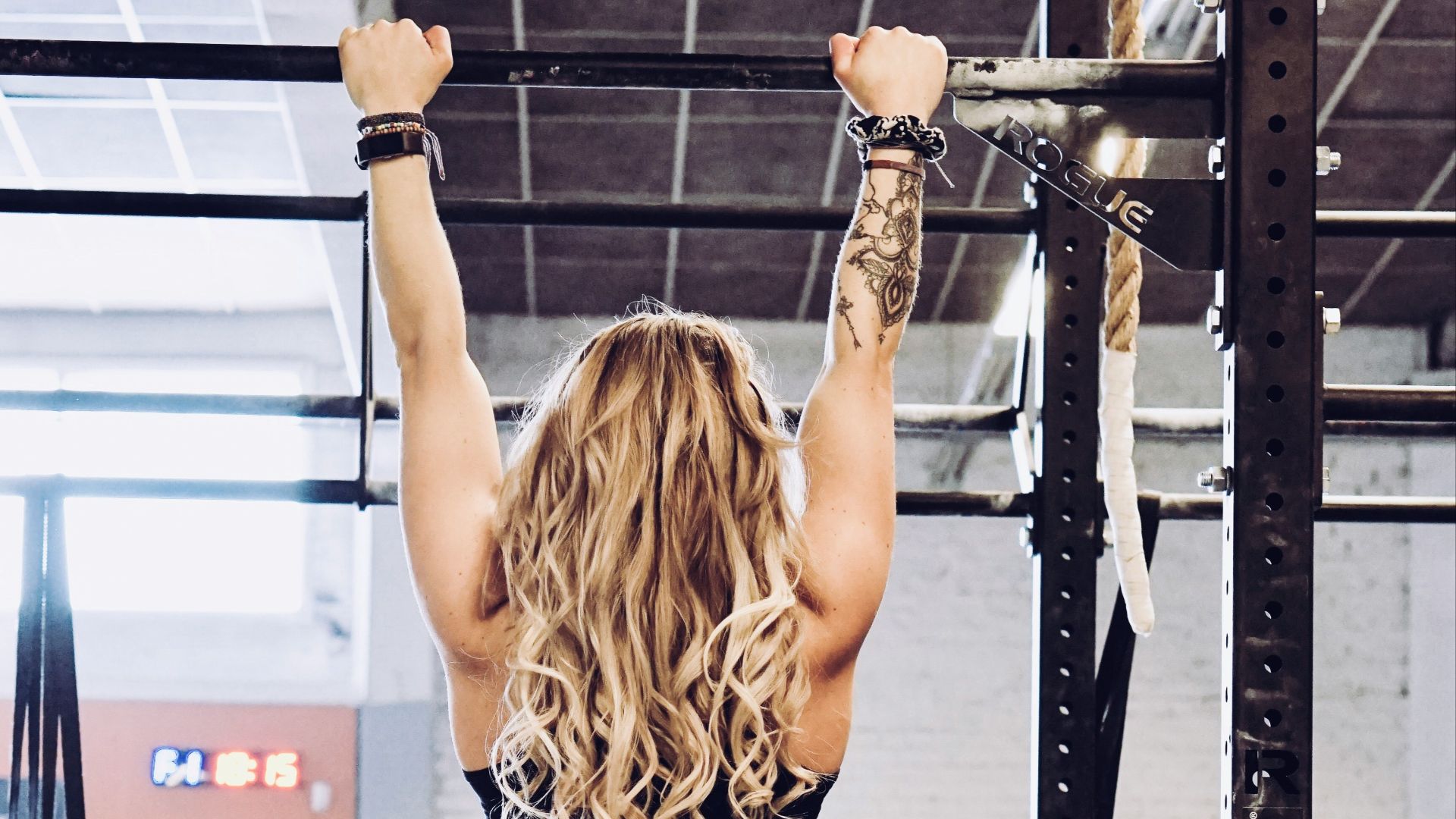 woman hanging on exercise equipment