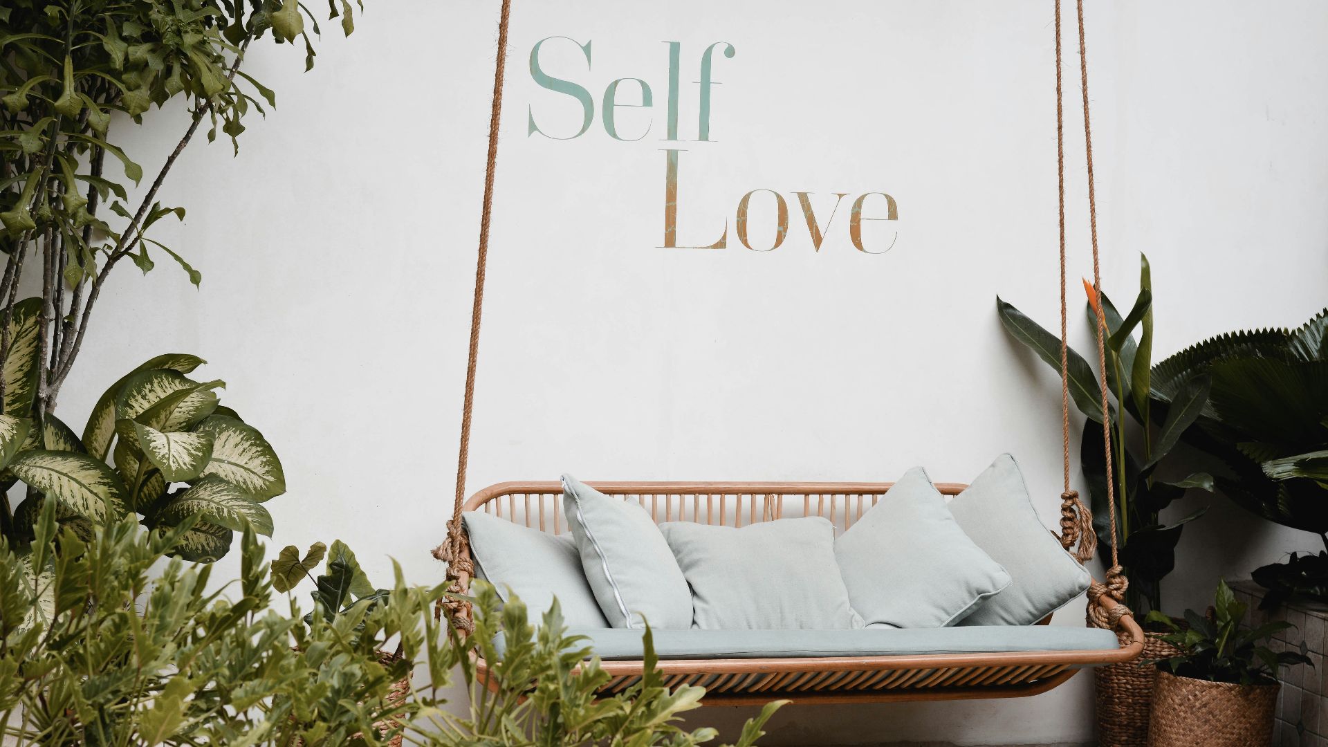 brown rattan swing bench with cushions