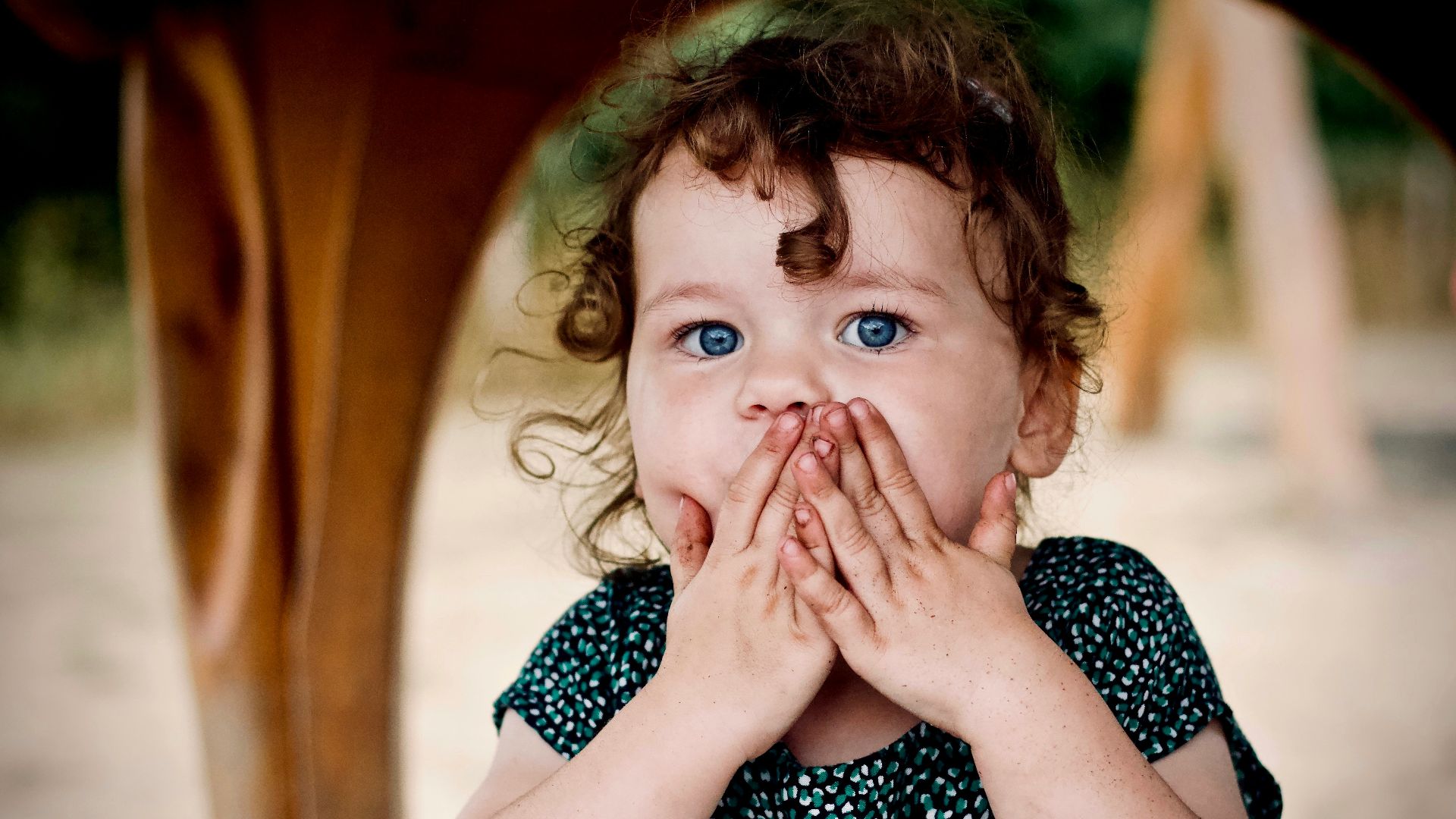 toddler holding her lips