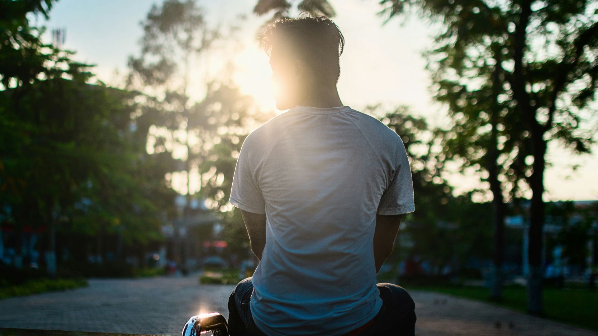 man sitting on road