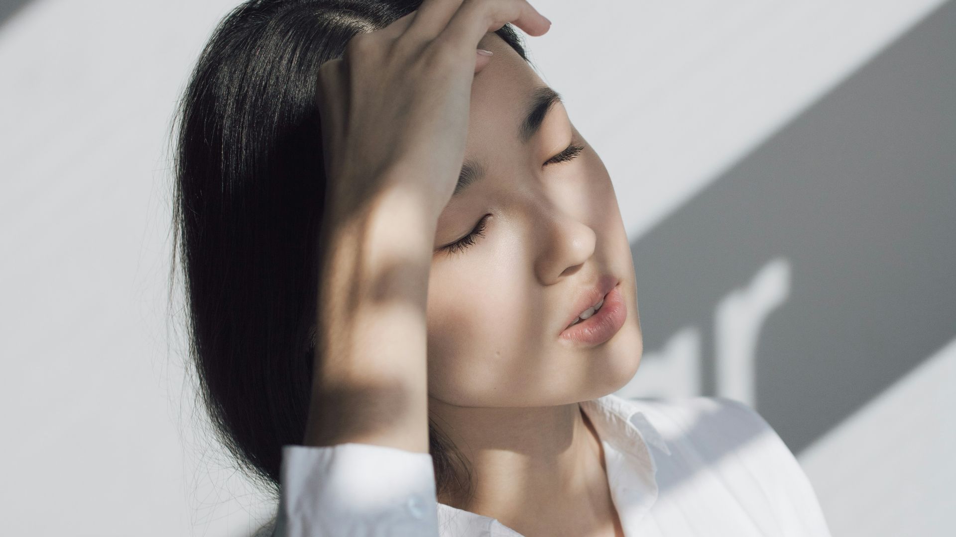 woman leaning on white table