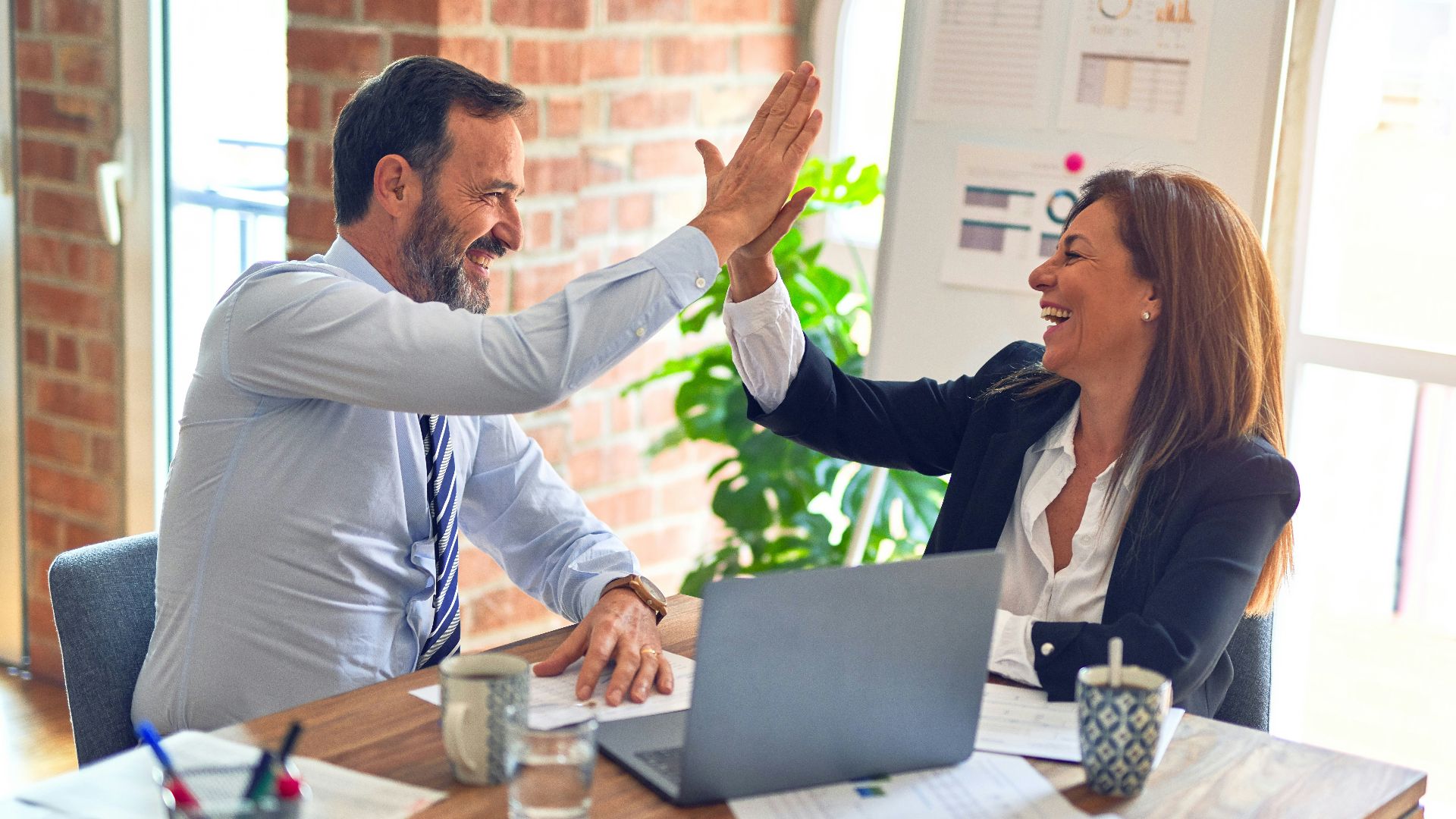 man in white dress shirt sitting beside woman in black long sleeve shirt