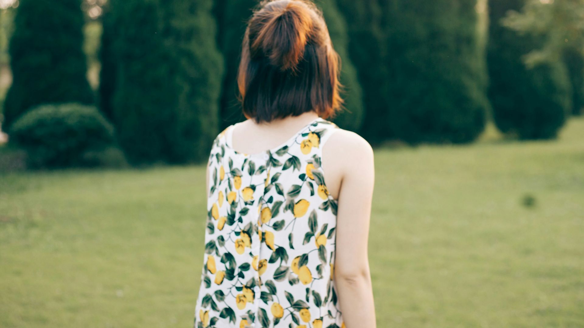 woman walking on lawn during daytime