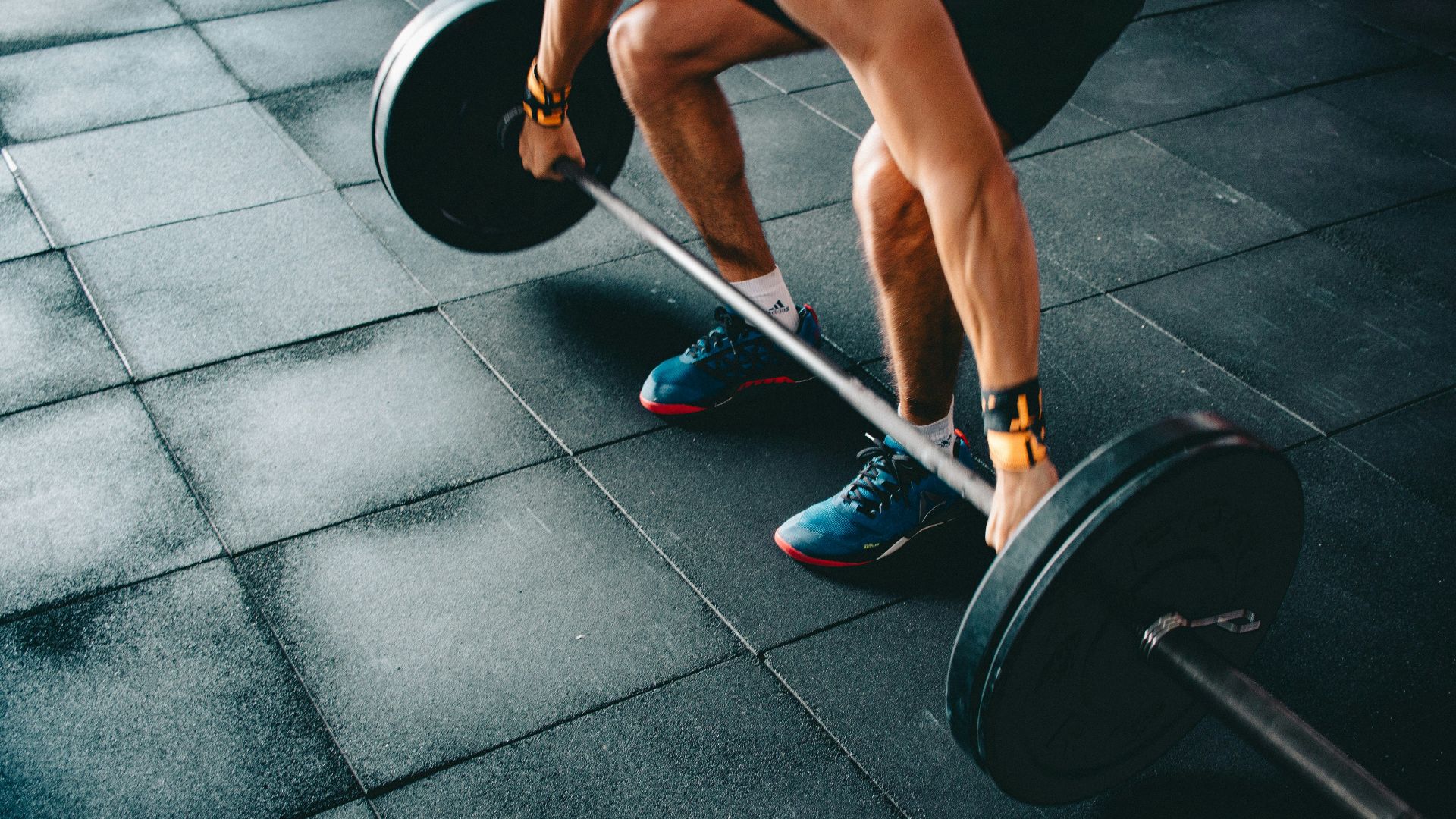 person holding black barbell