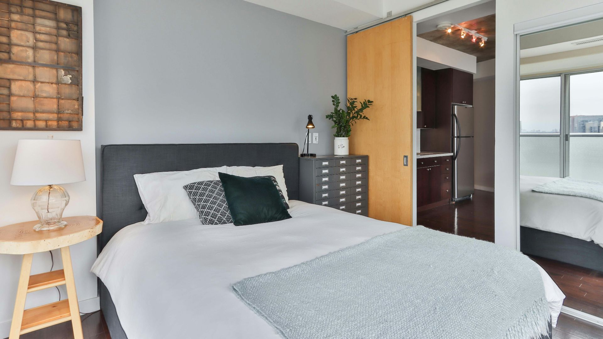 white bed linen near brown wooden door