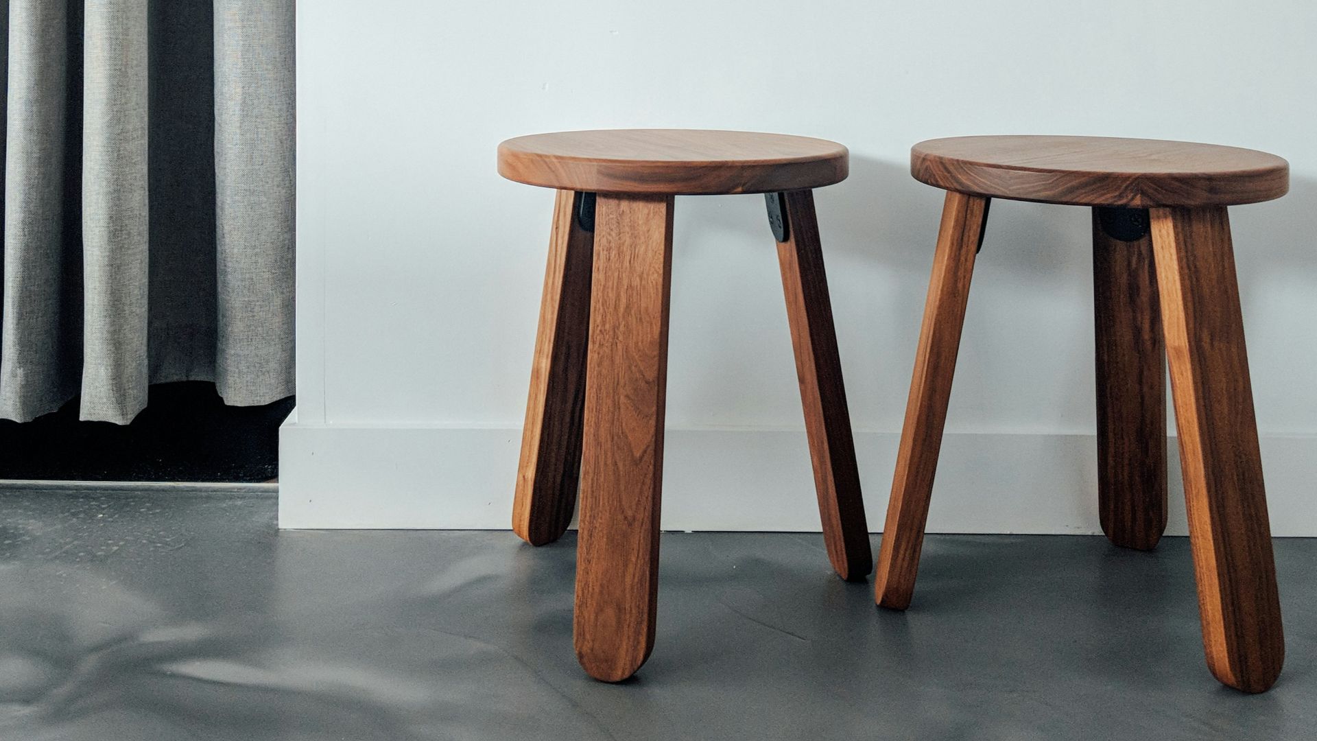 two brown wooden stools