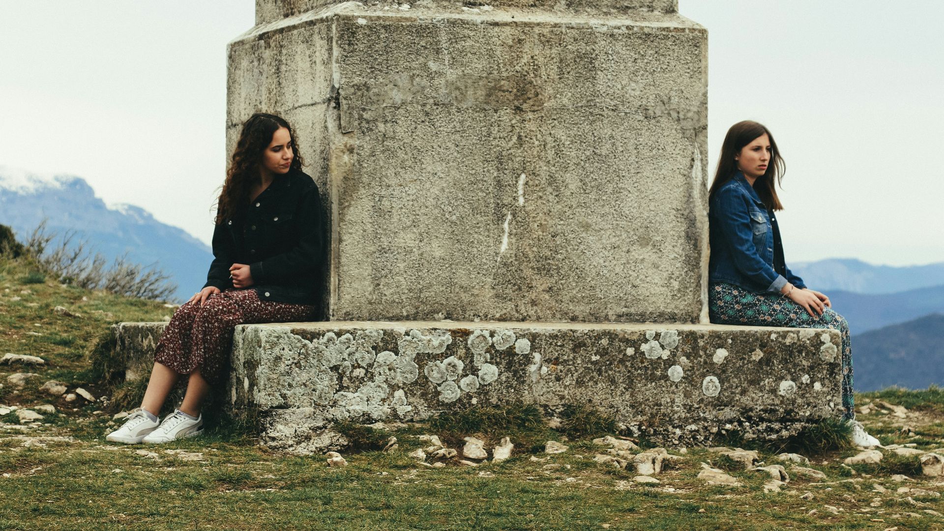 woman in black jacket sitting beside woman in black jacket