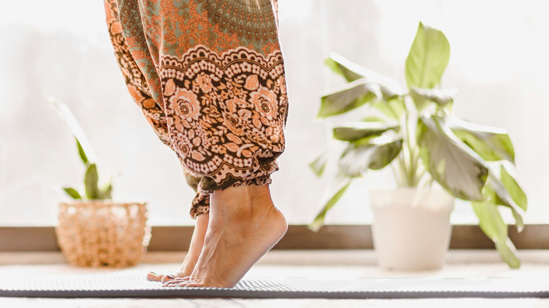 person in brown and beige floral skirt standing on white table