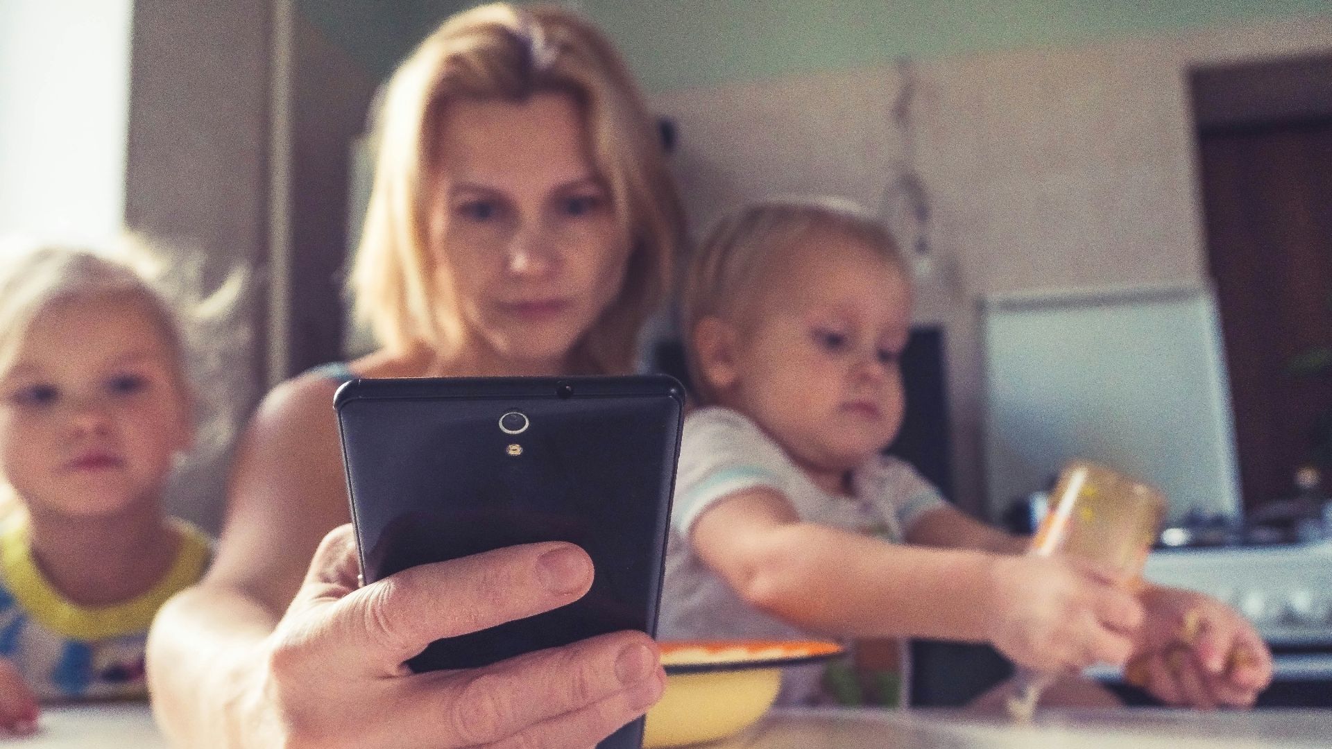 woman in white shirt holding black ipad