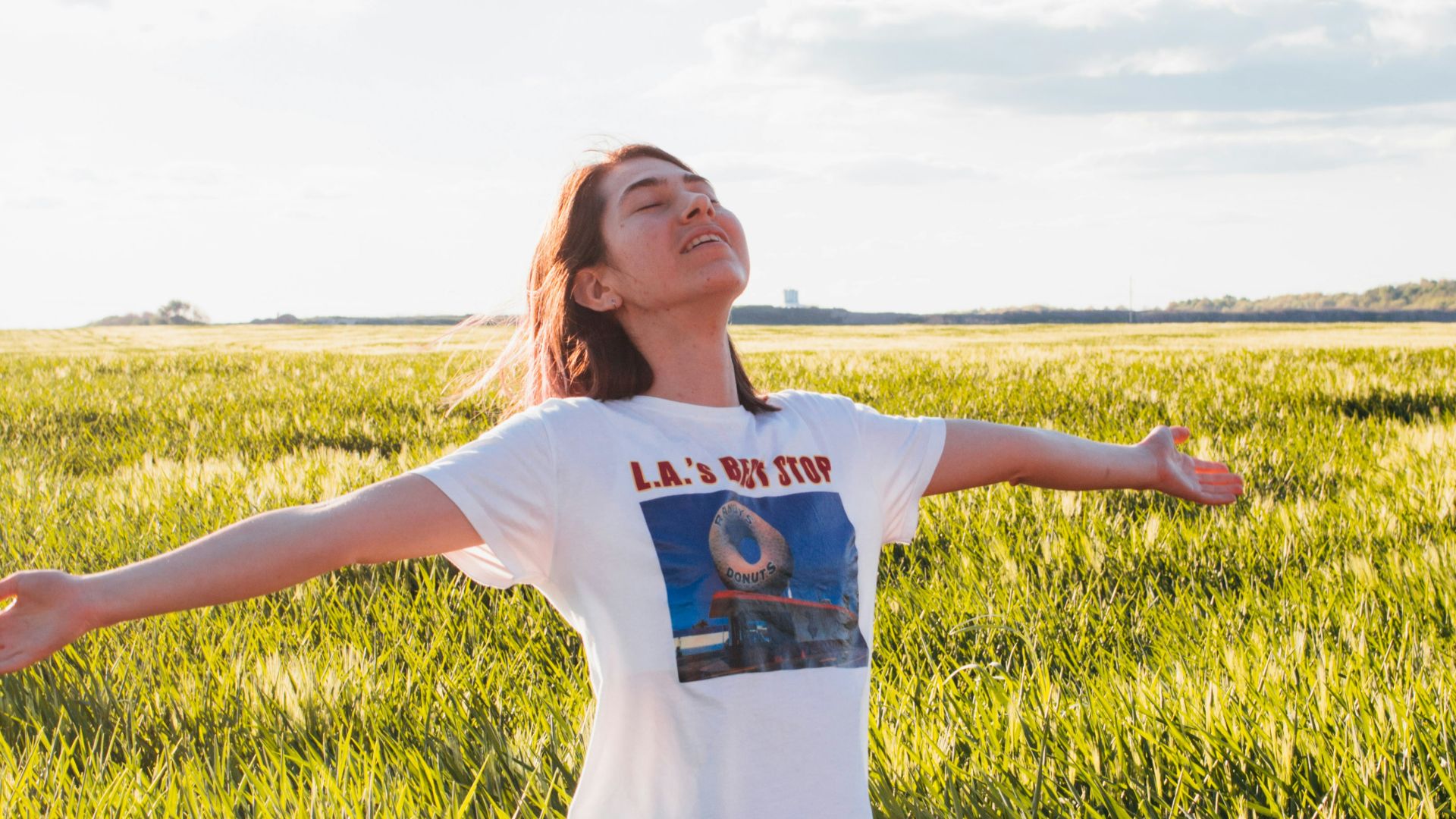 woman standing in green field