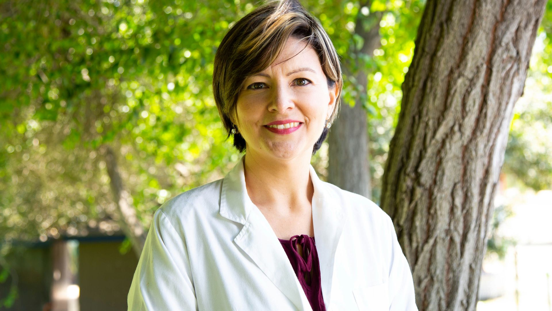 woman standing under tree
