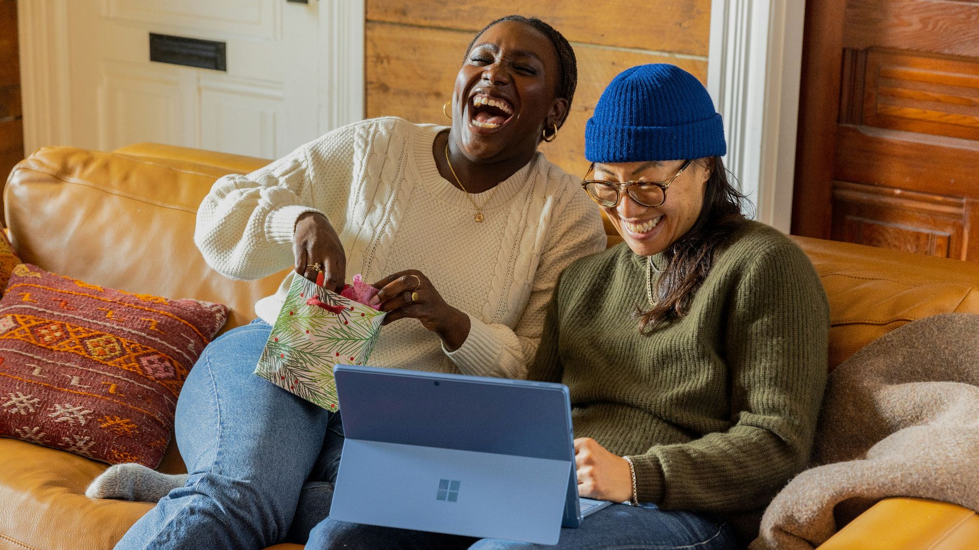 a person sitting on a couch with a laptop