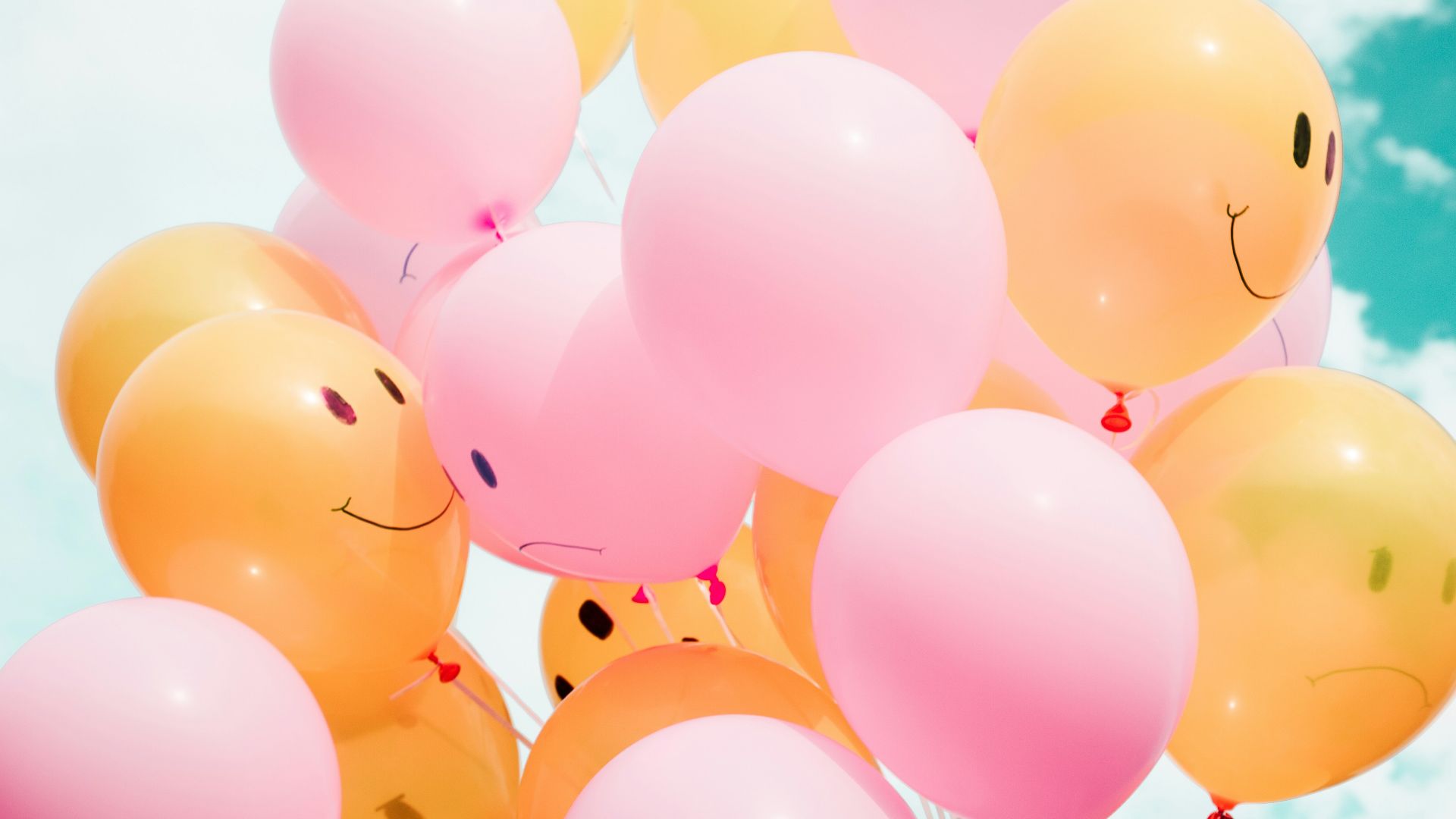 low-angle photo of pink and orange balloons
