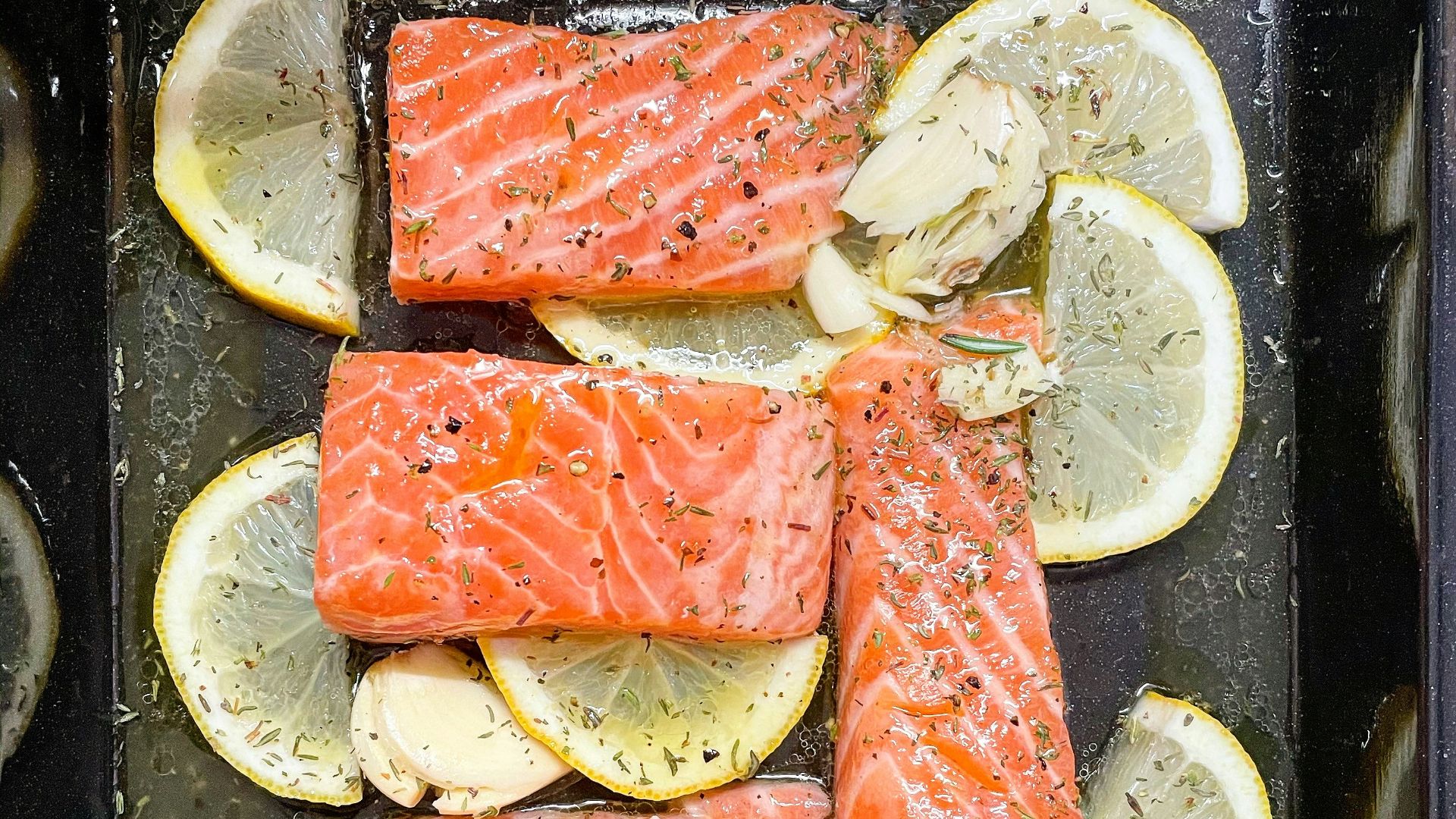 sliced fish meat on black plate