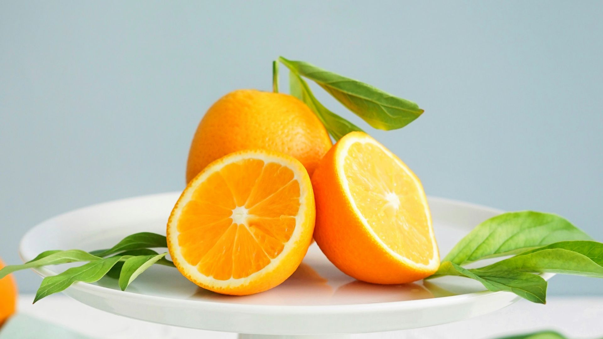 orange fruit in white ceramic plate close-up photography