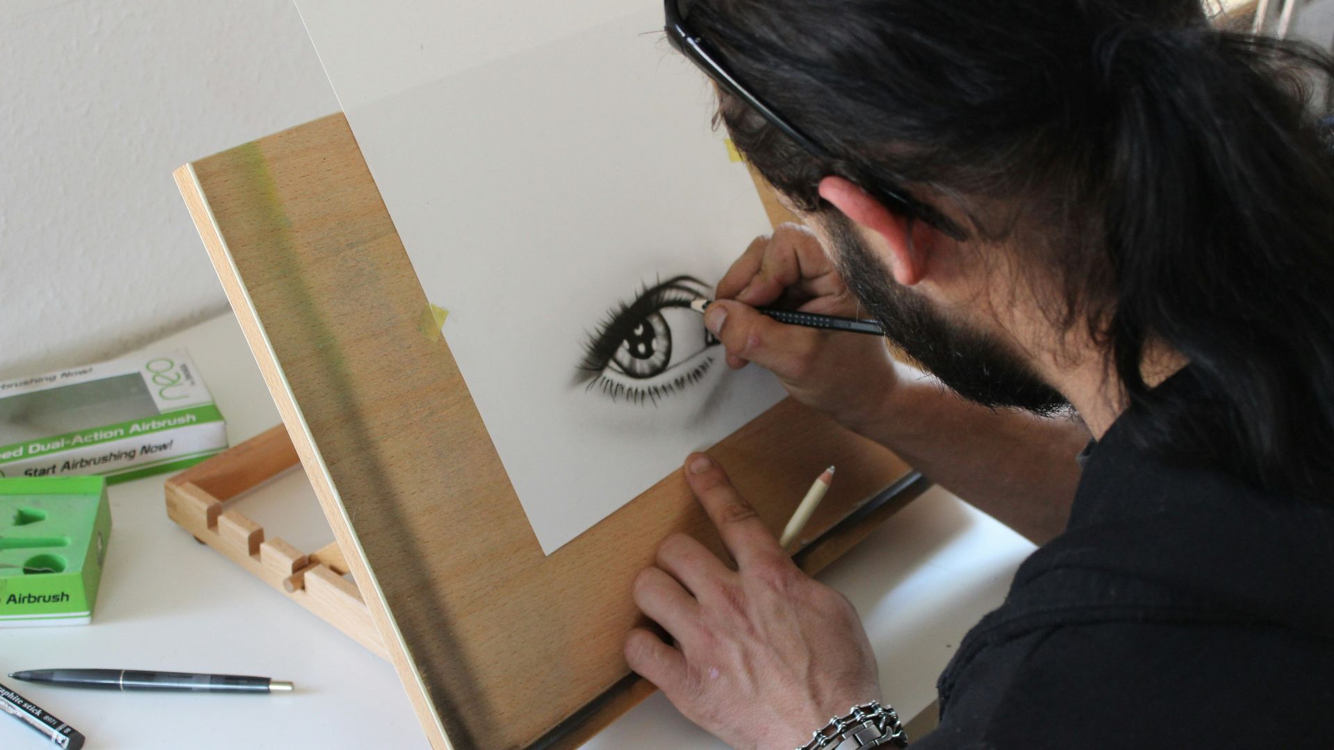 man painting human eye