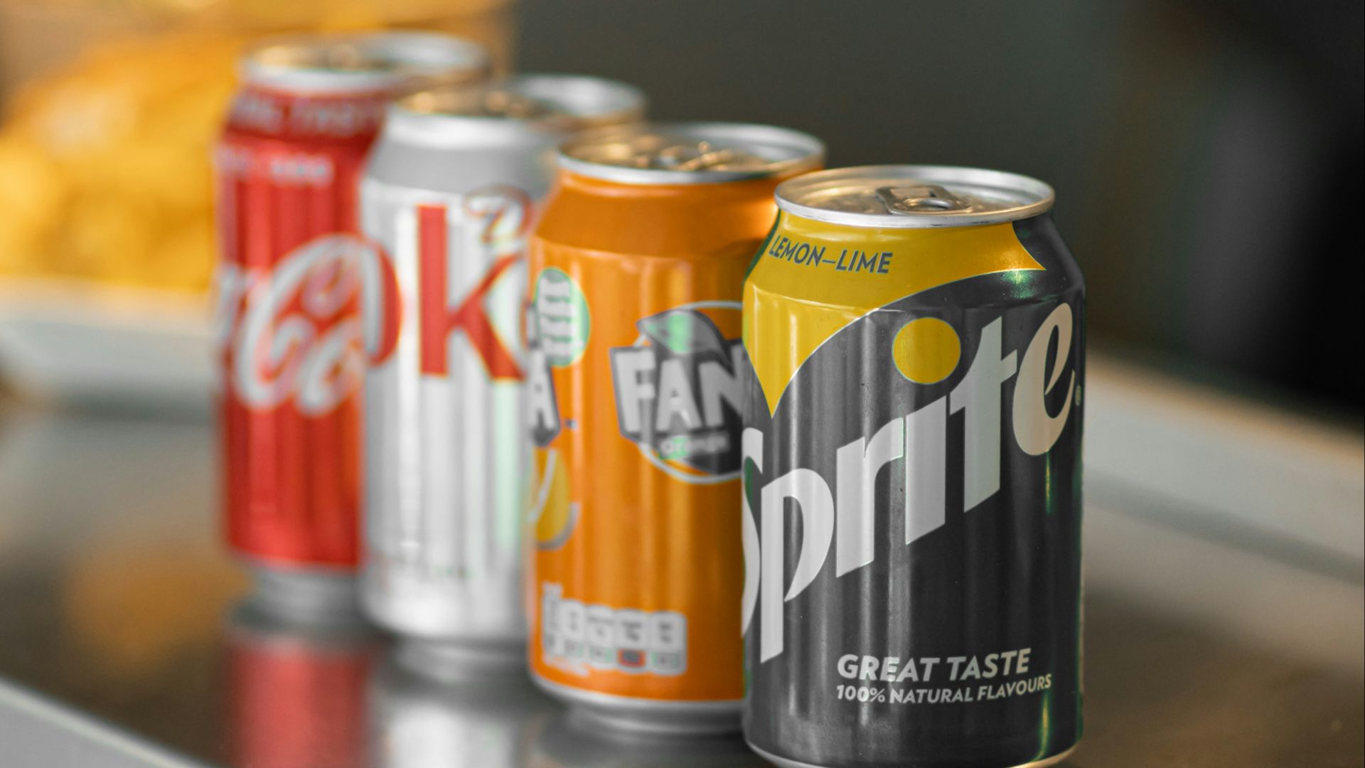 two coca cola cans on stainless steel table