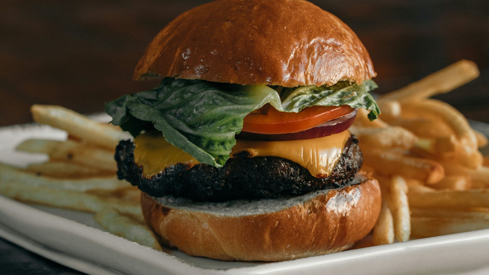 a cheeseburger and fries on a plate on a table
