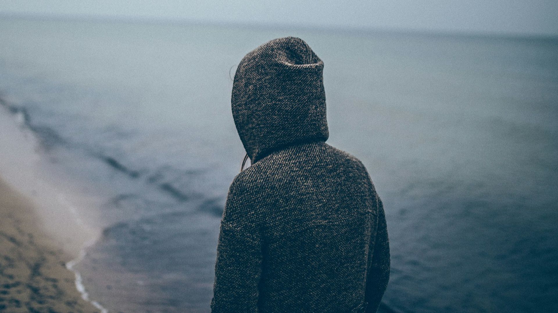 person standing beside seashore