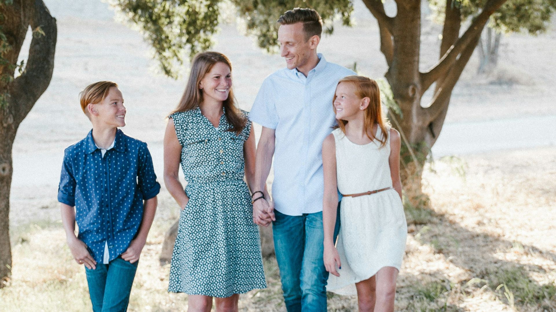 family standing in front of trees
