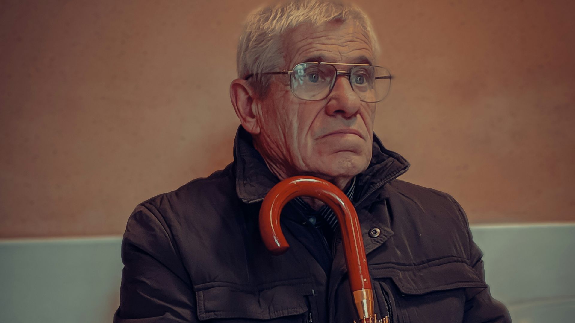 man in black jacket wearing eyeglasses