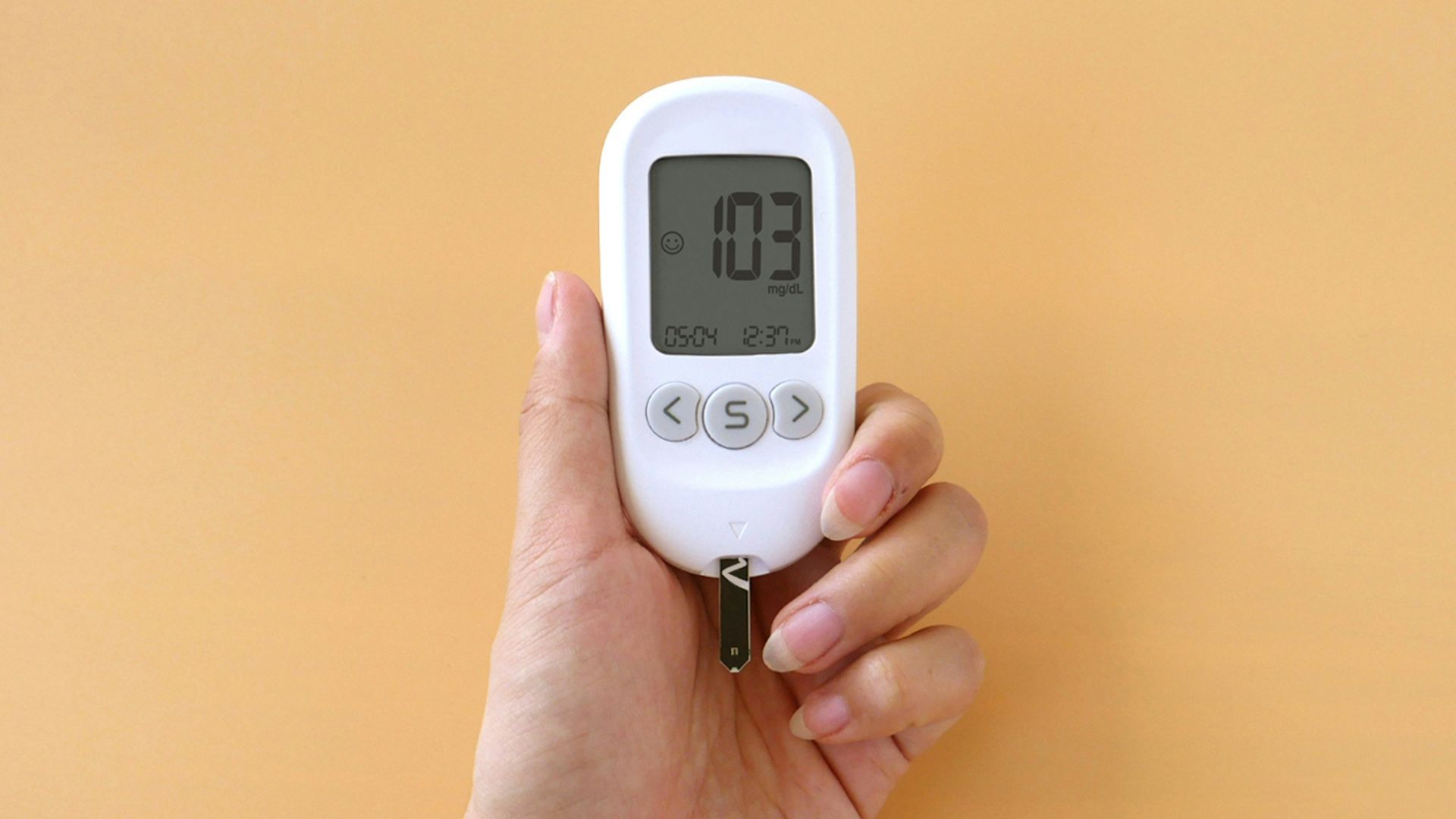 a person holding a digital thermometer in their hand