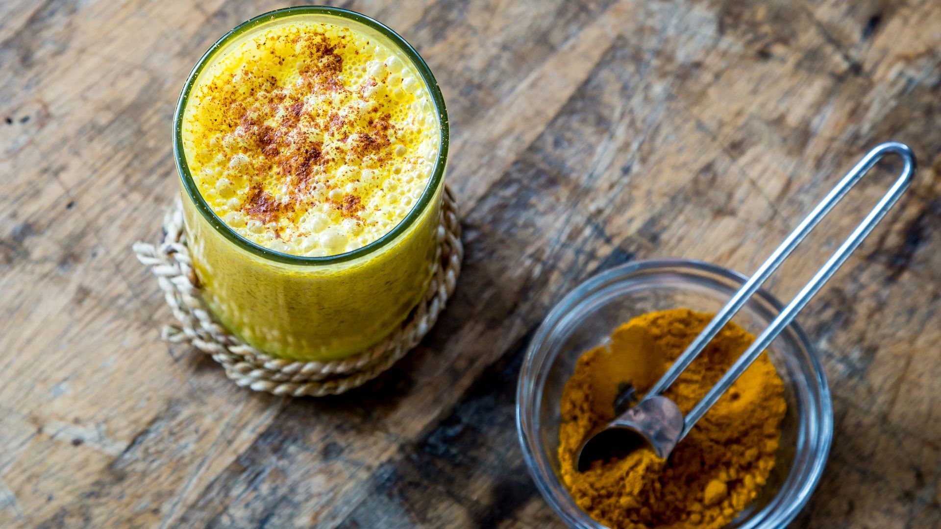 clear drinking glass full of orange liquid