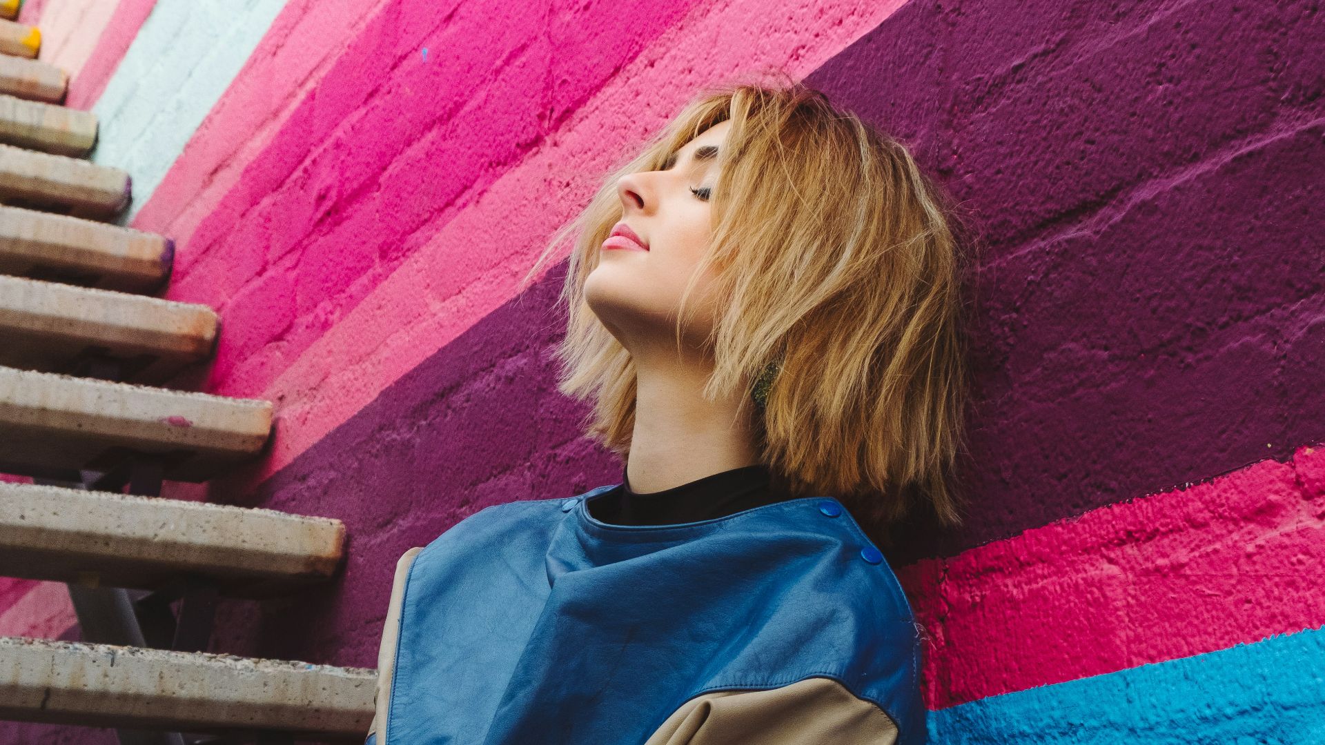 woman leaning on wall