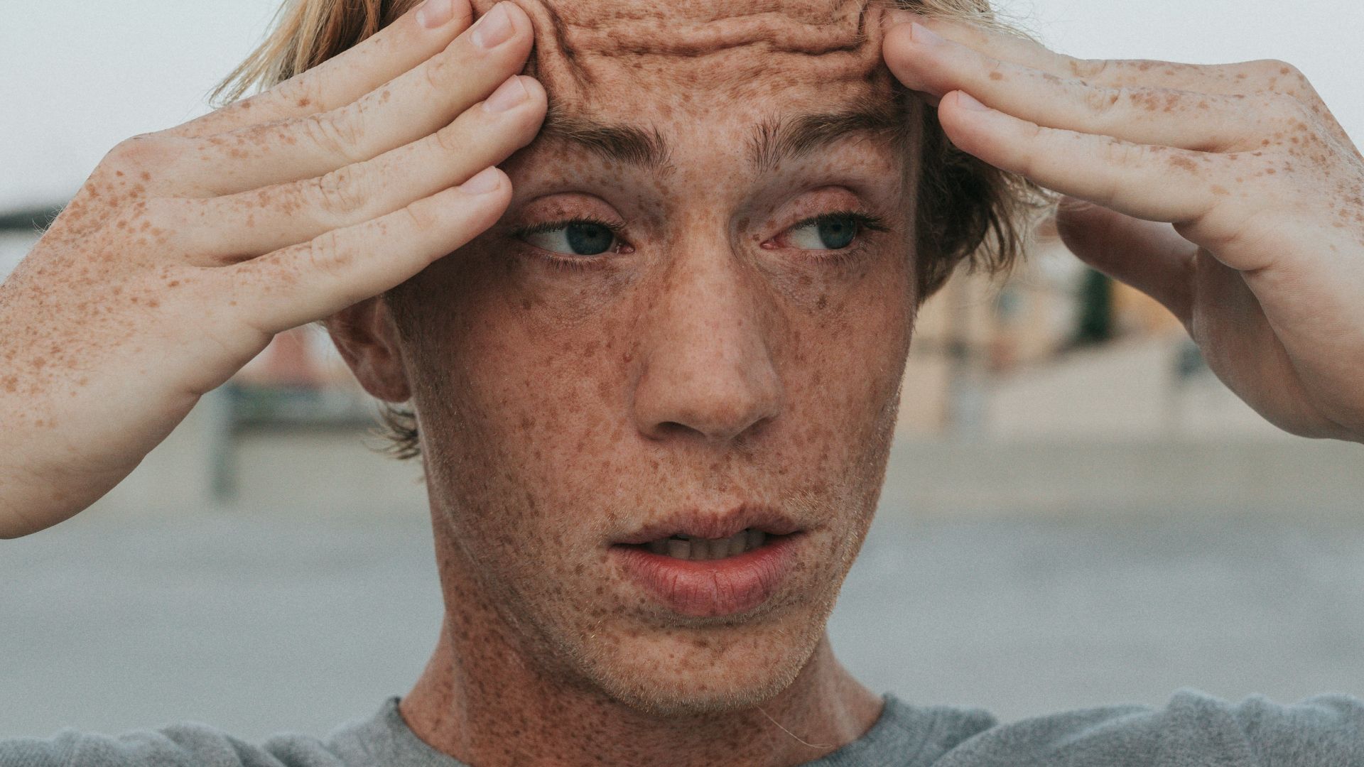man in gray crew neck shirt with brown hair