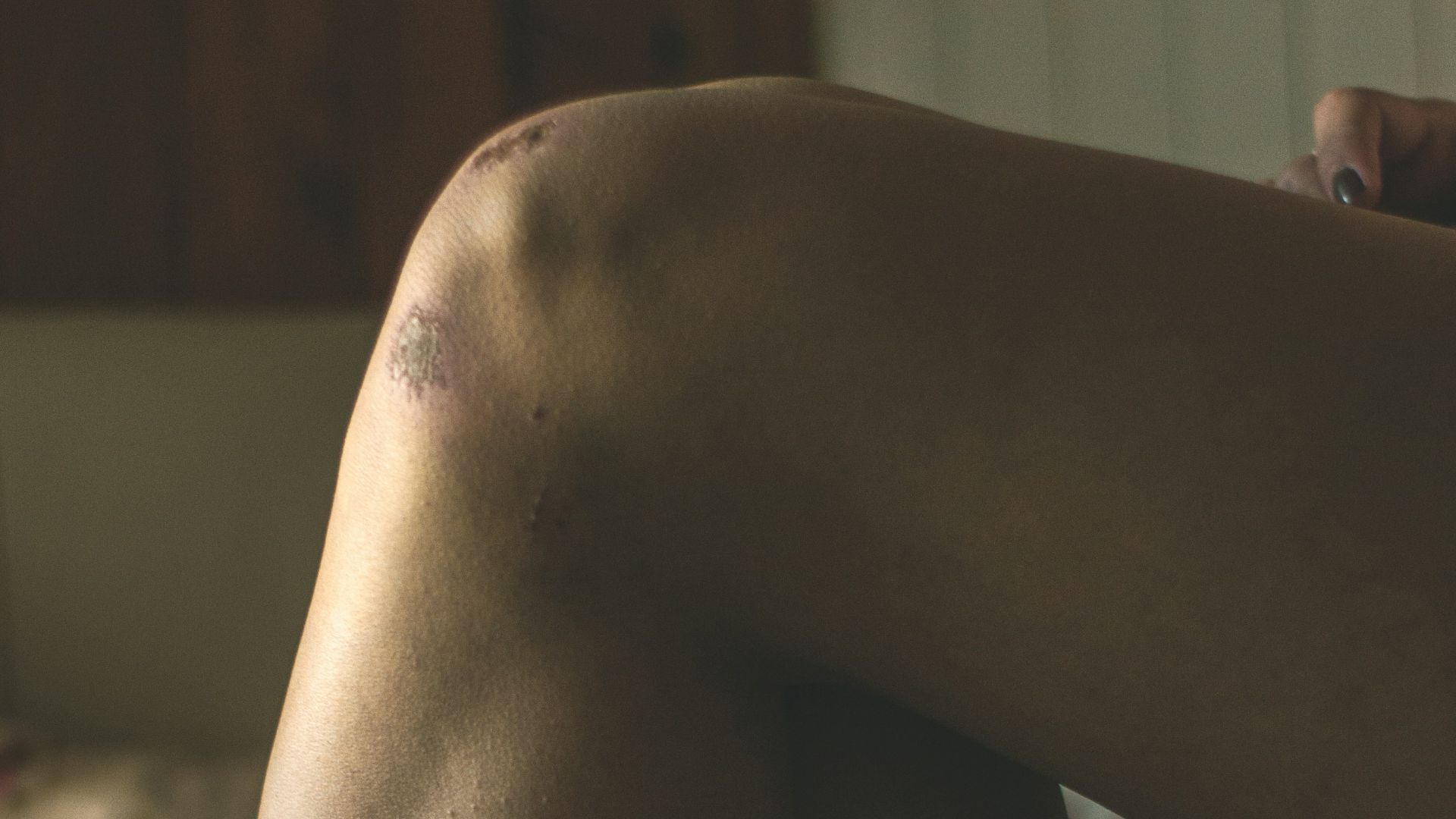 person lying on gray textile