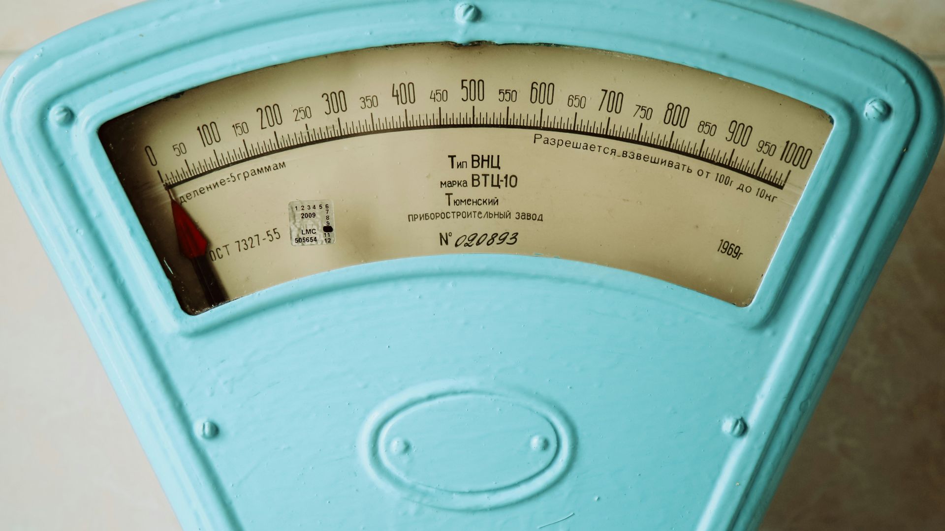 a close up of a meter on a tiled wall