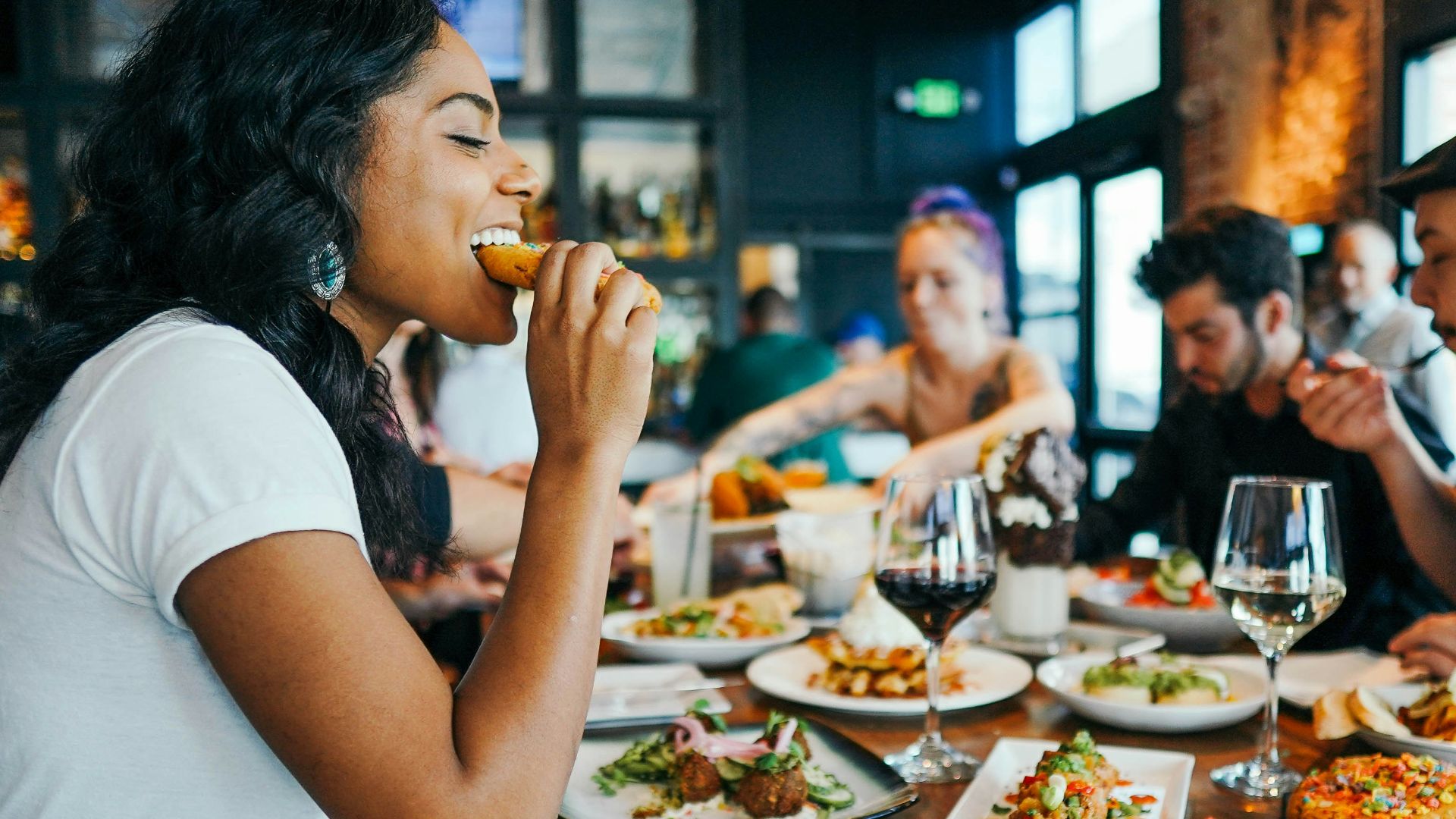 woman in white shirt eating