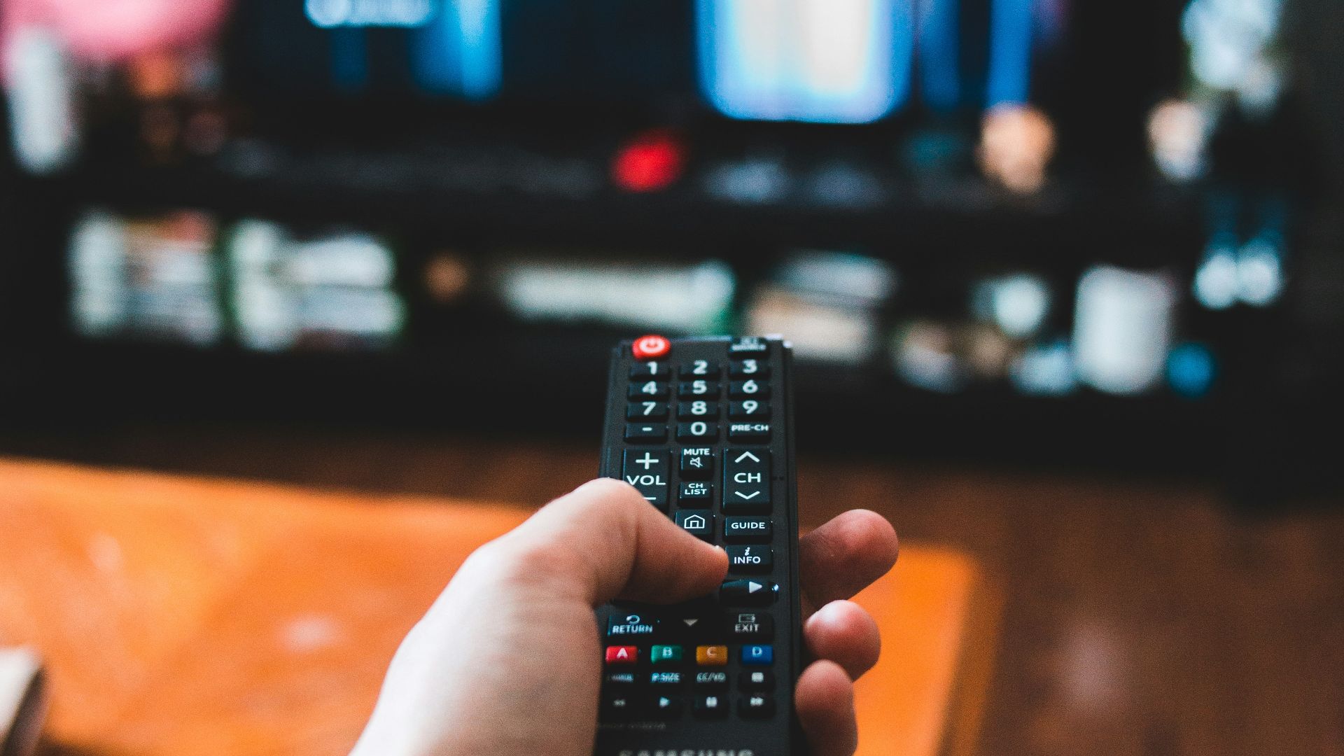person holding black remote control