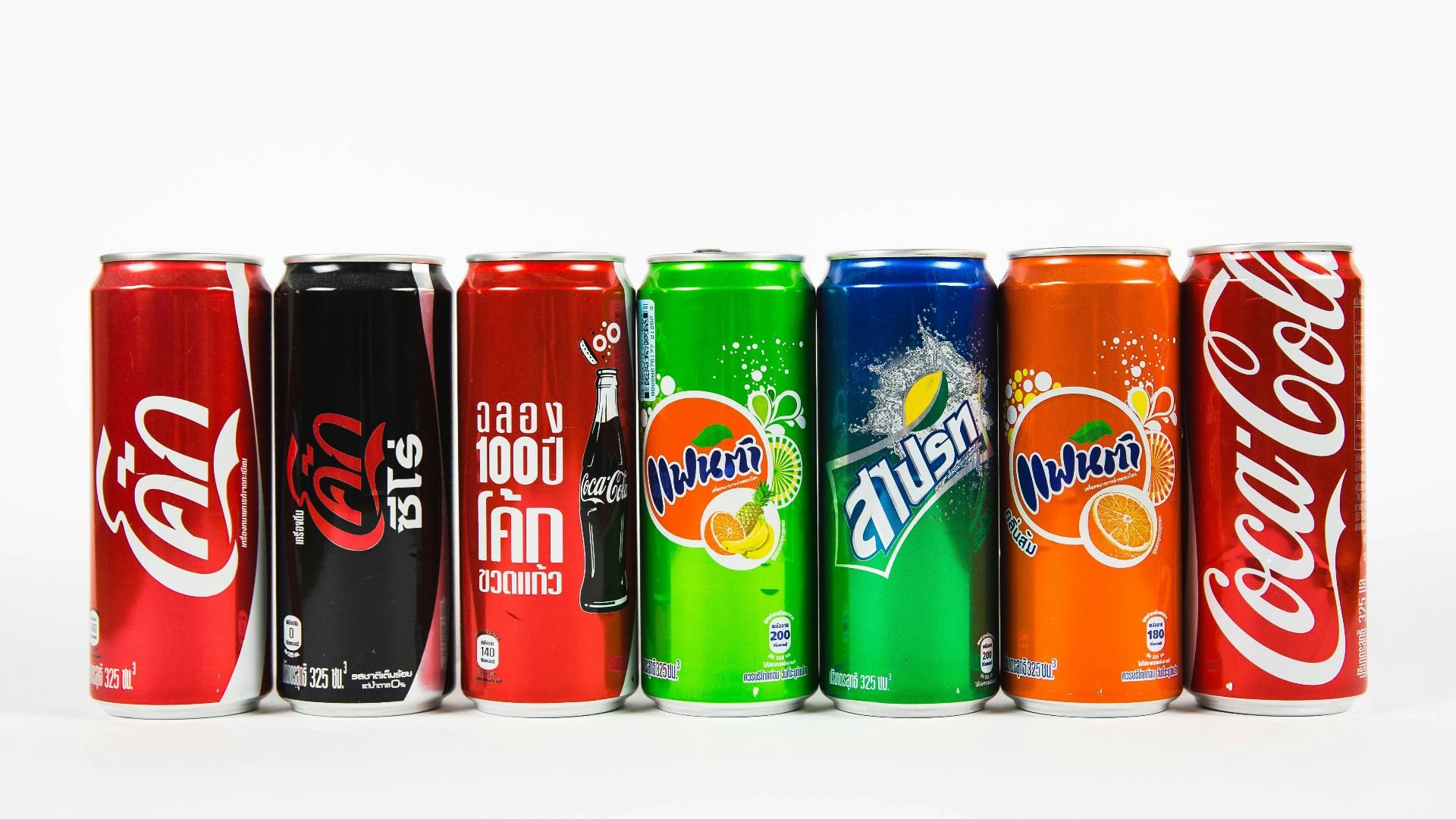 seven assorted-brand soda cans
