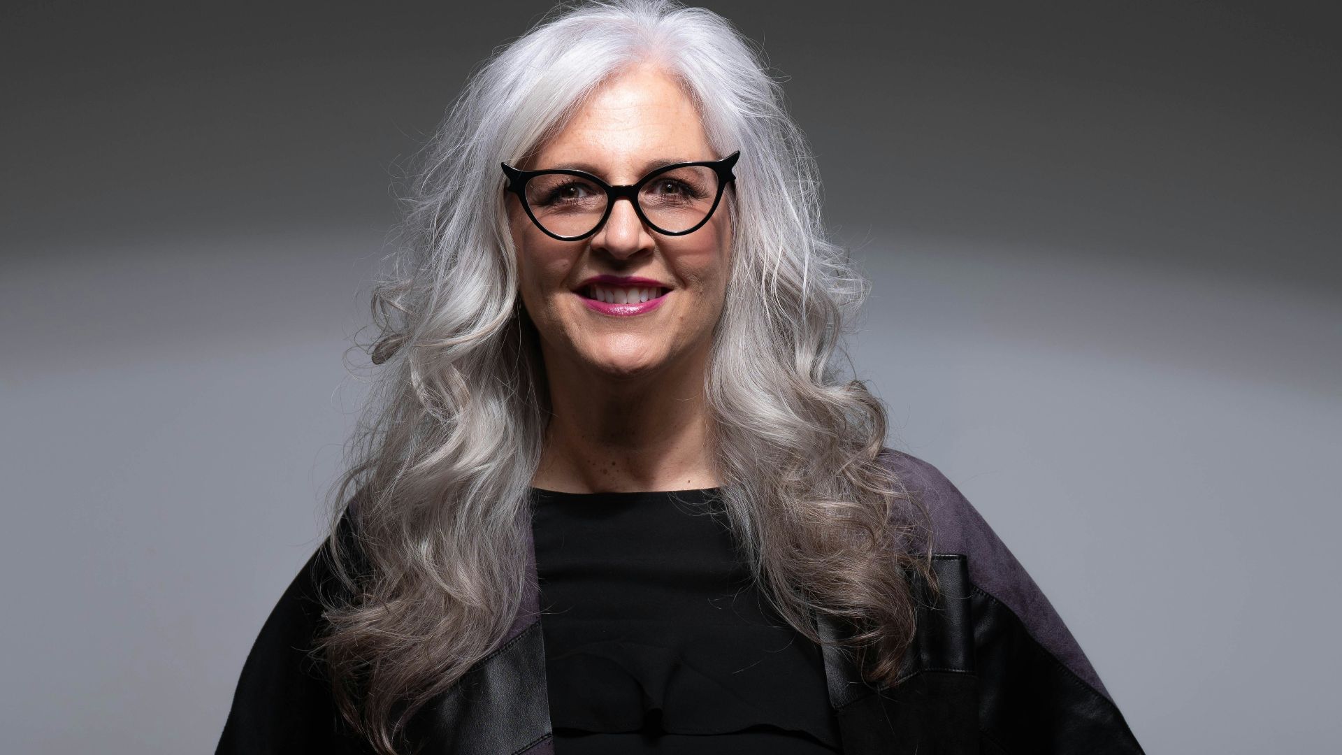 woman in black coat wearing eyeglasses