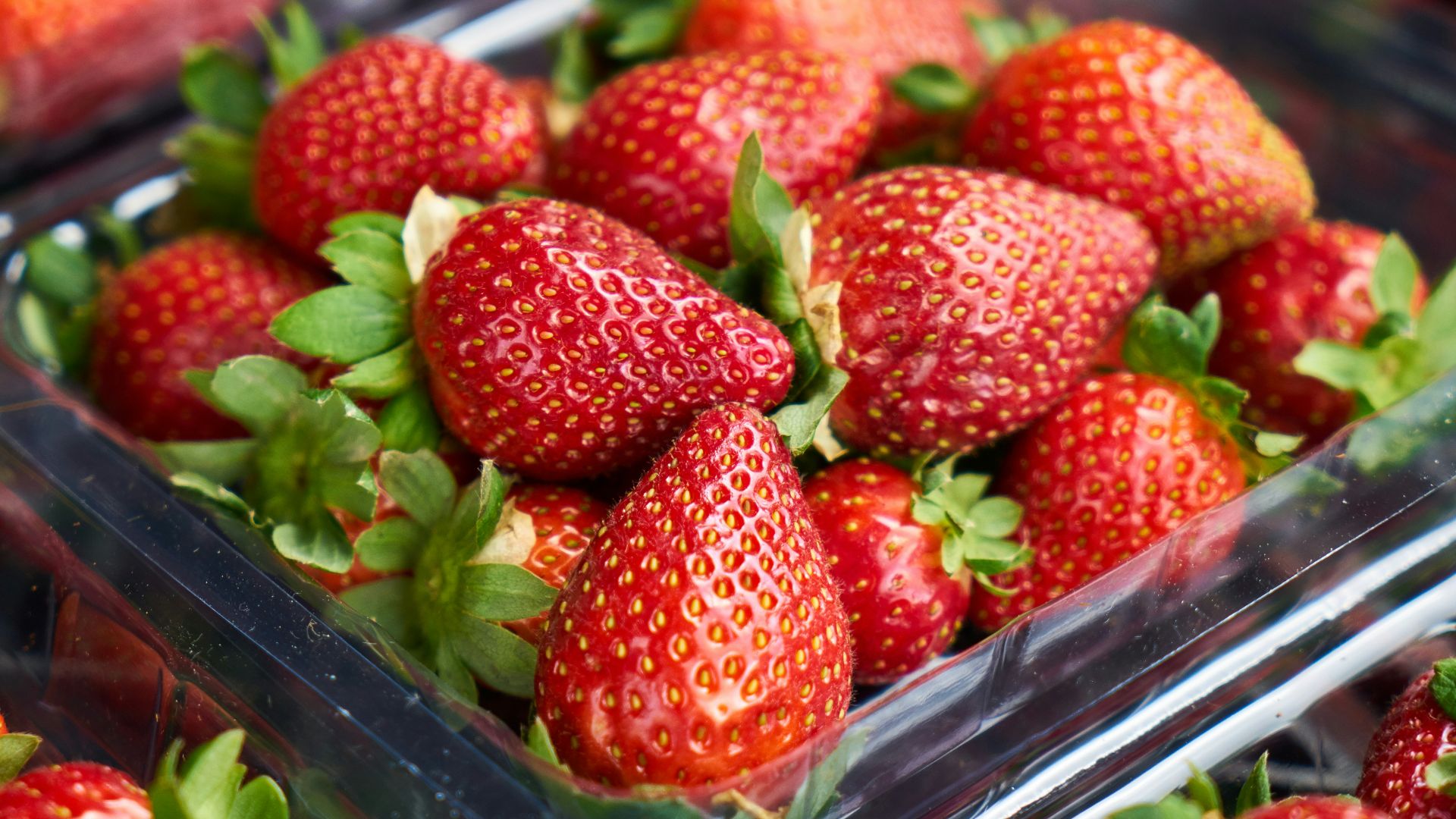strawberries on clear plastic container