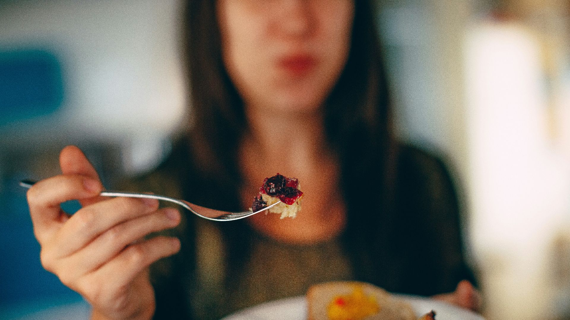 woman holding plate of cake