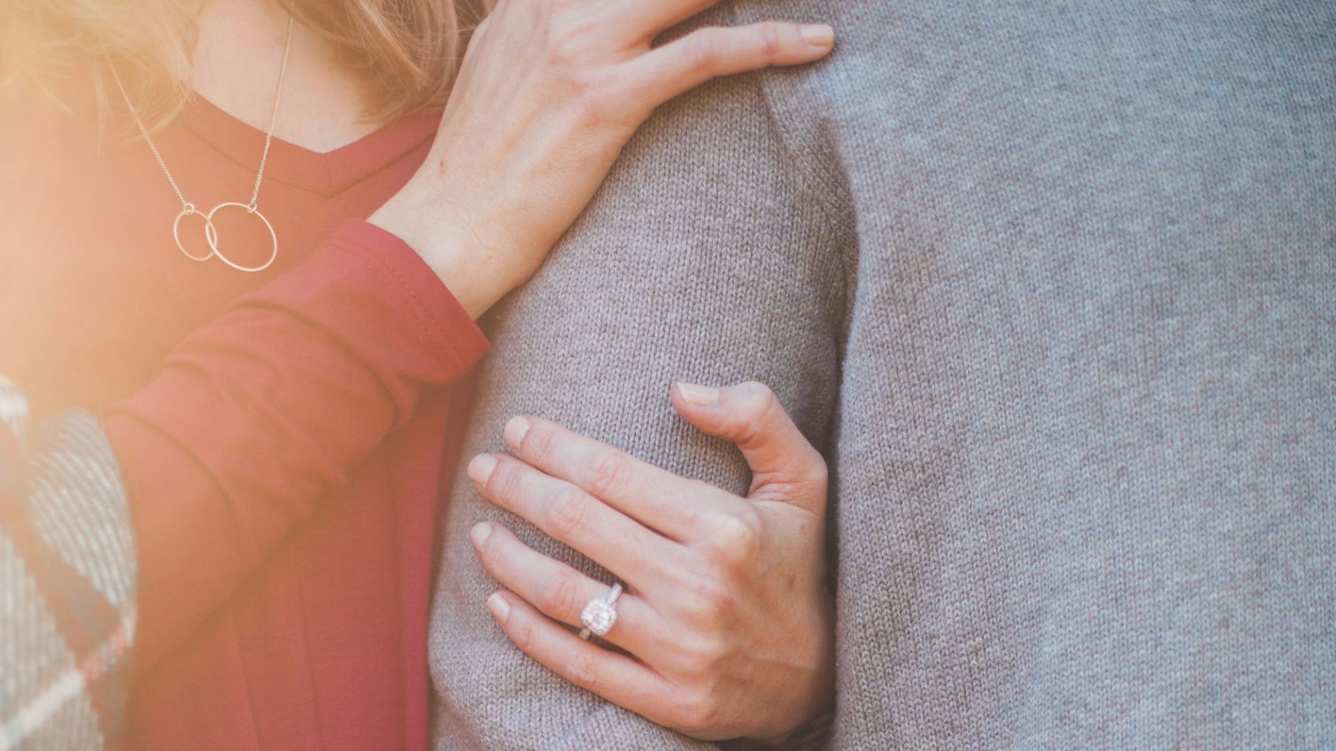 woman holding the shoulder of man