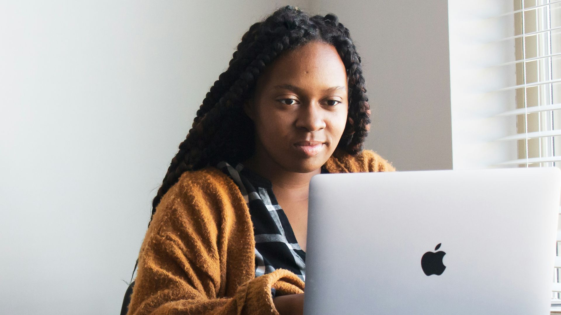 woman in brown and white fur coat sitting on chair