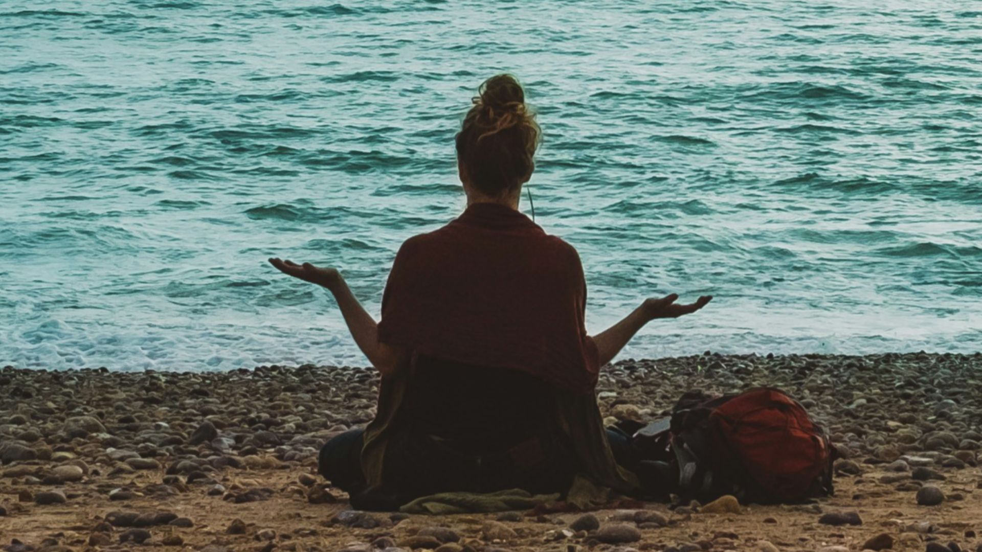 person doing yoga on seashore during daytime
