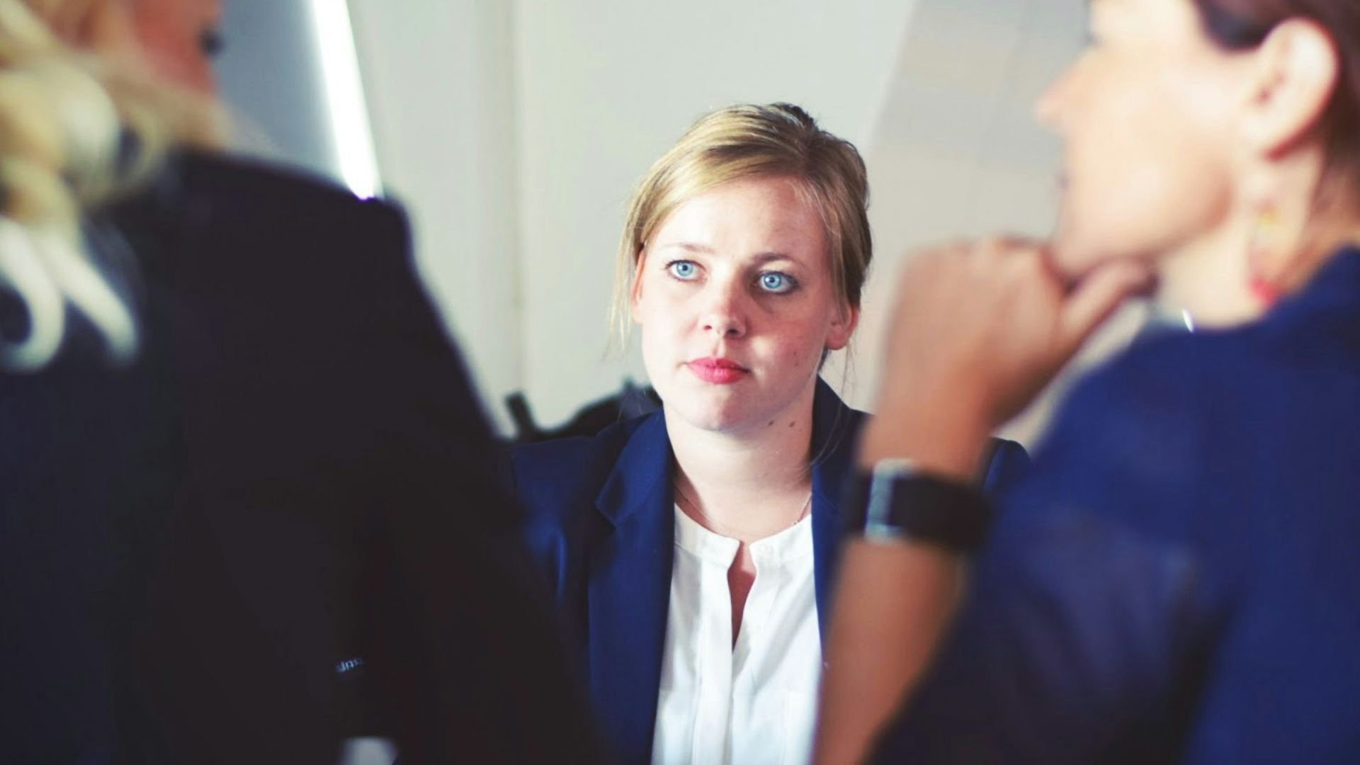 three women sitting beside table