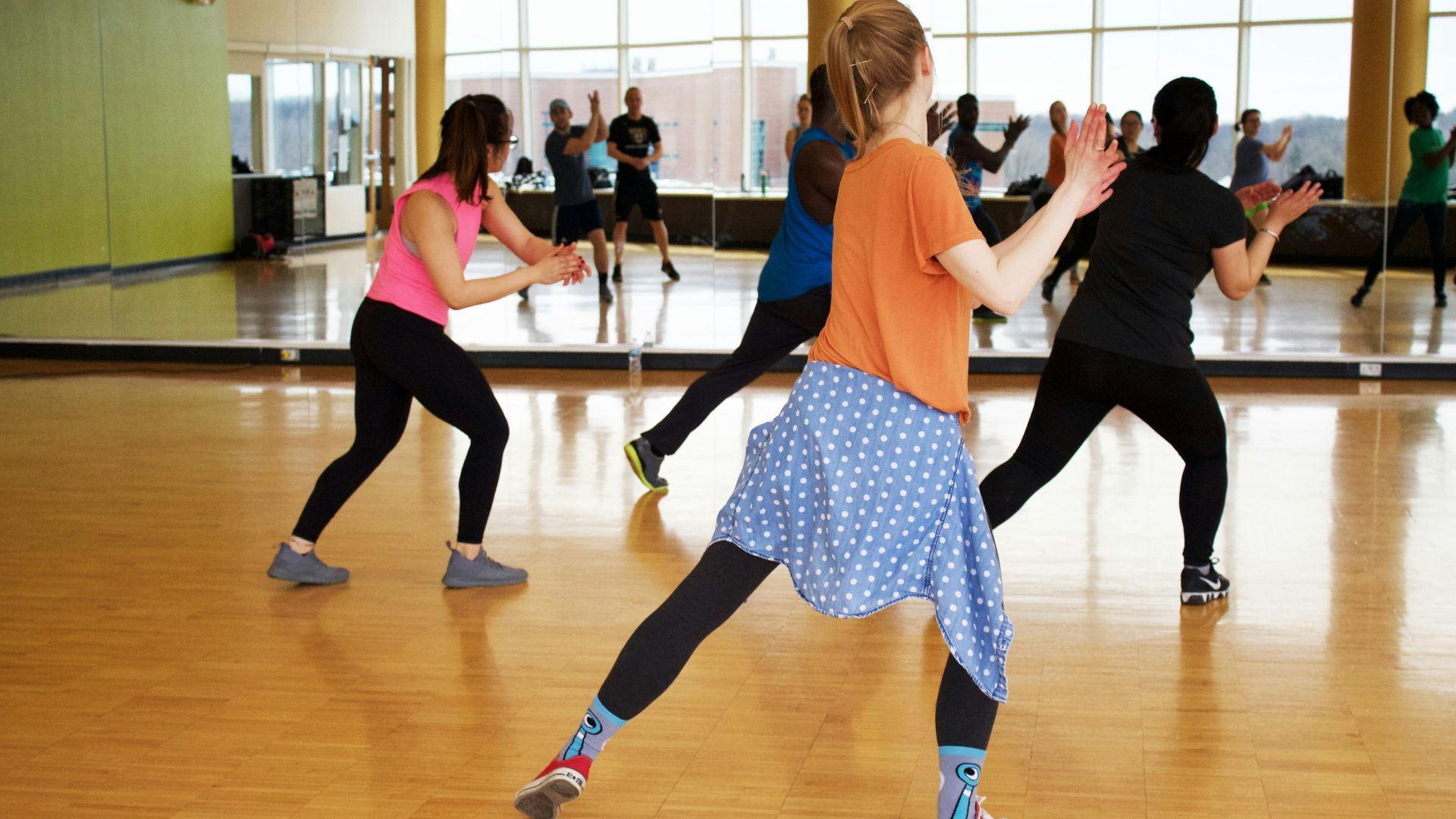 women dancing near mirror
