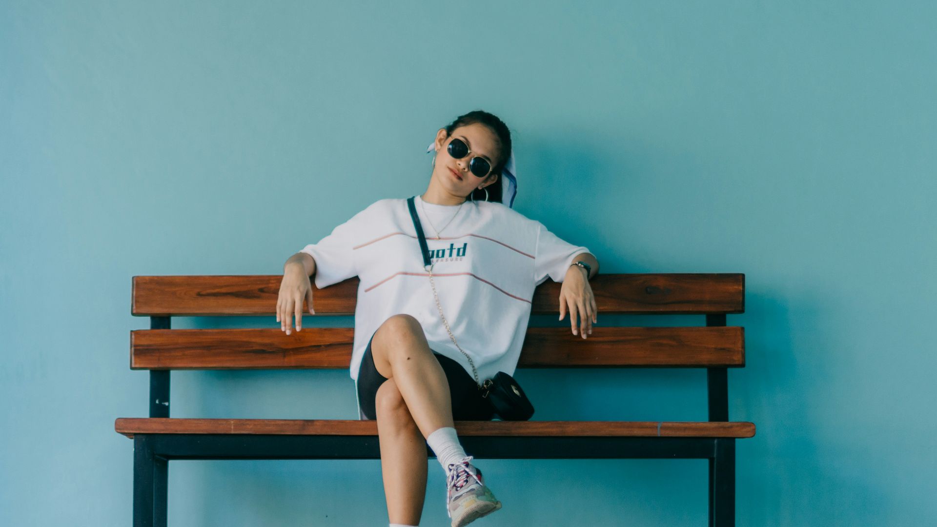 woman sitting on brown bench