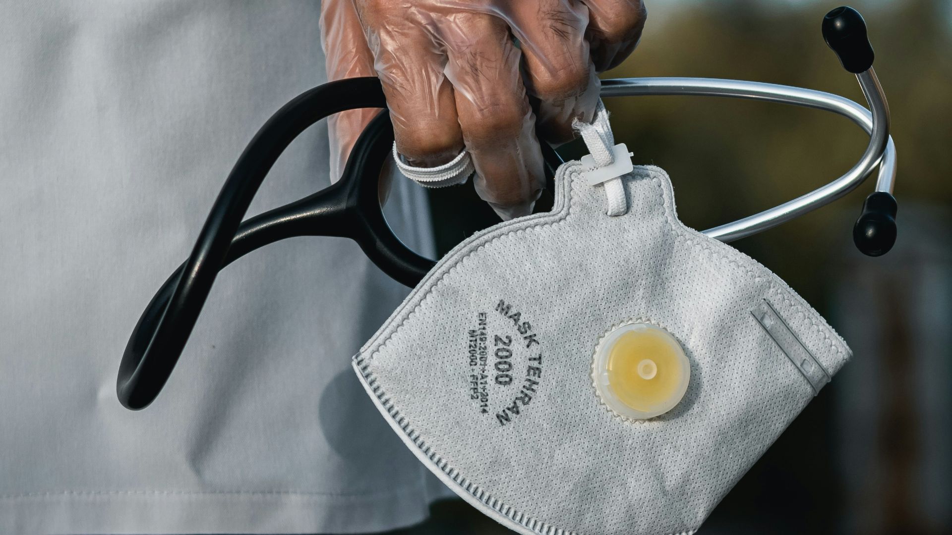 person in blue denim jeans with gray and black metal padlock