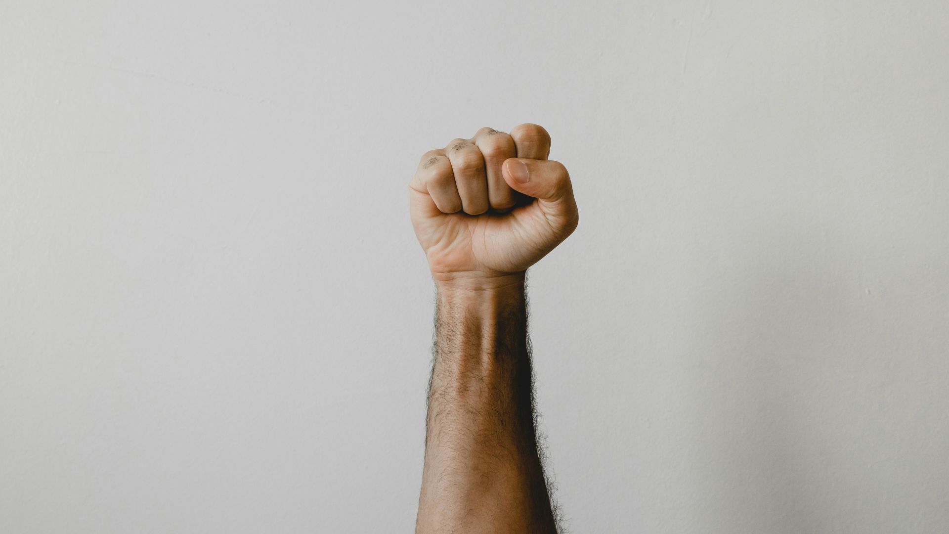 persons right foot on white wall