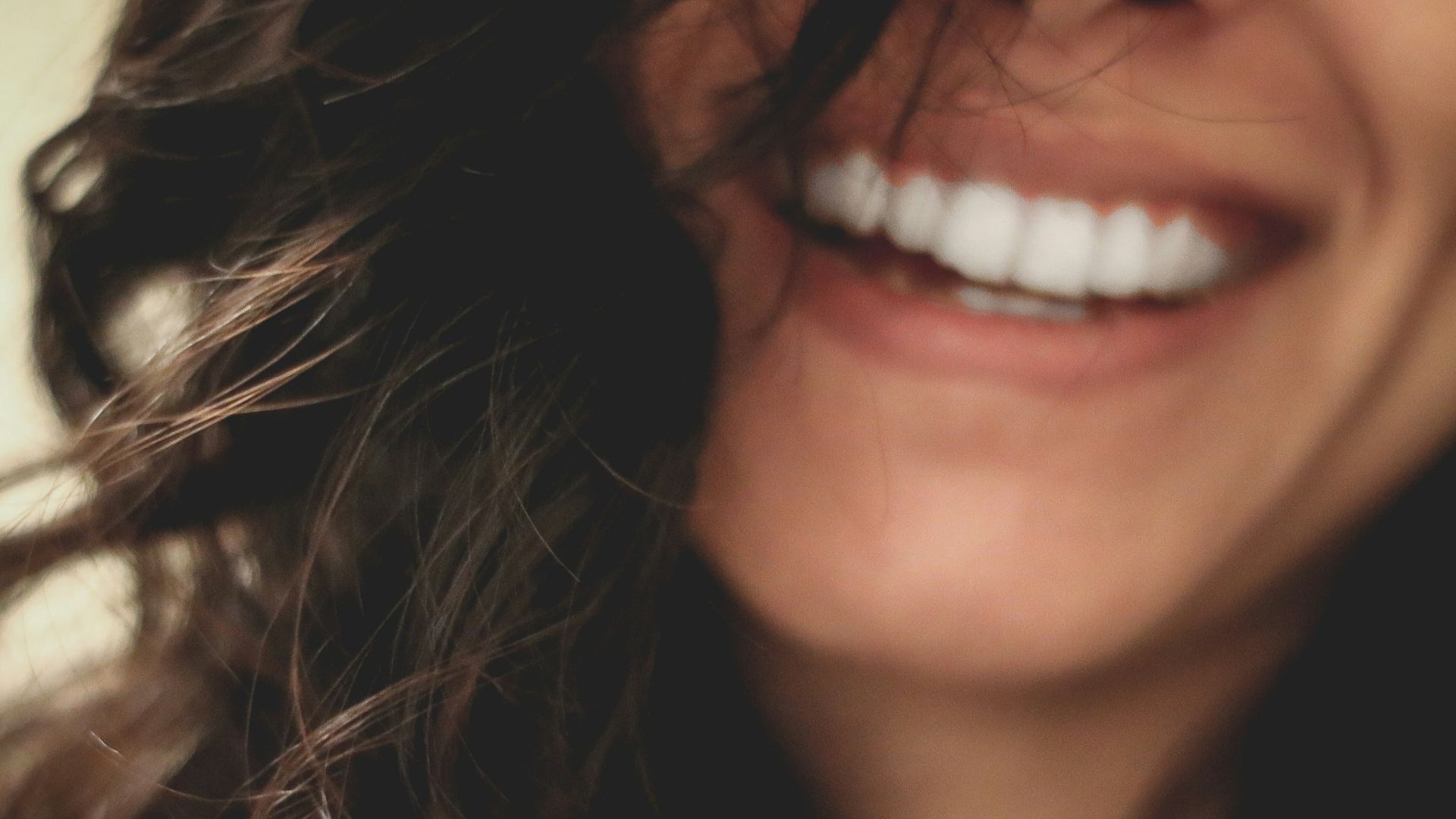 long black haired woman smiling close-up photography